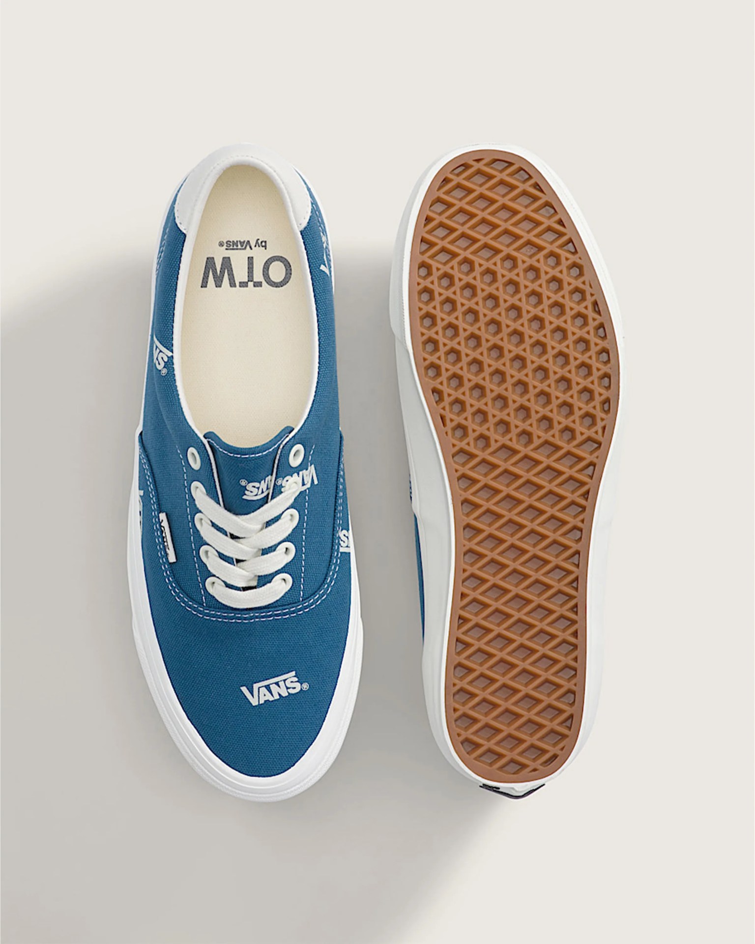 Blue Vans canvas sneaker with white laces and gum rubber waffle sole shown from top and bottom.