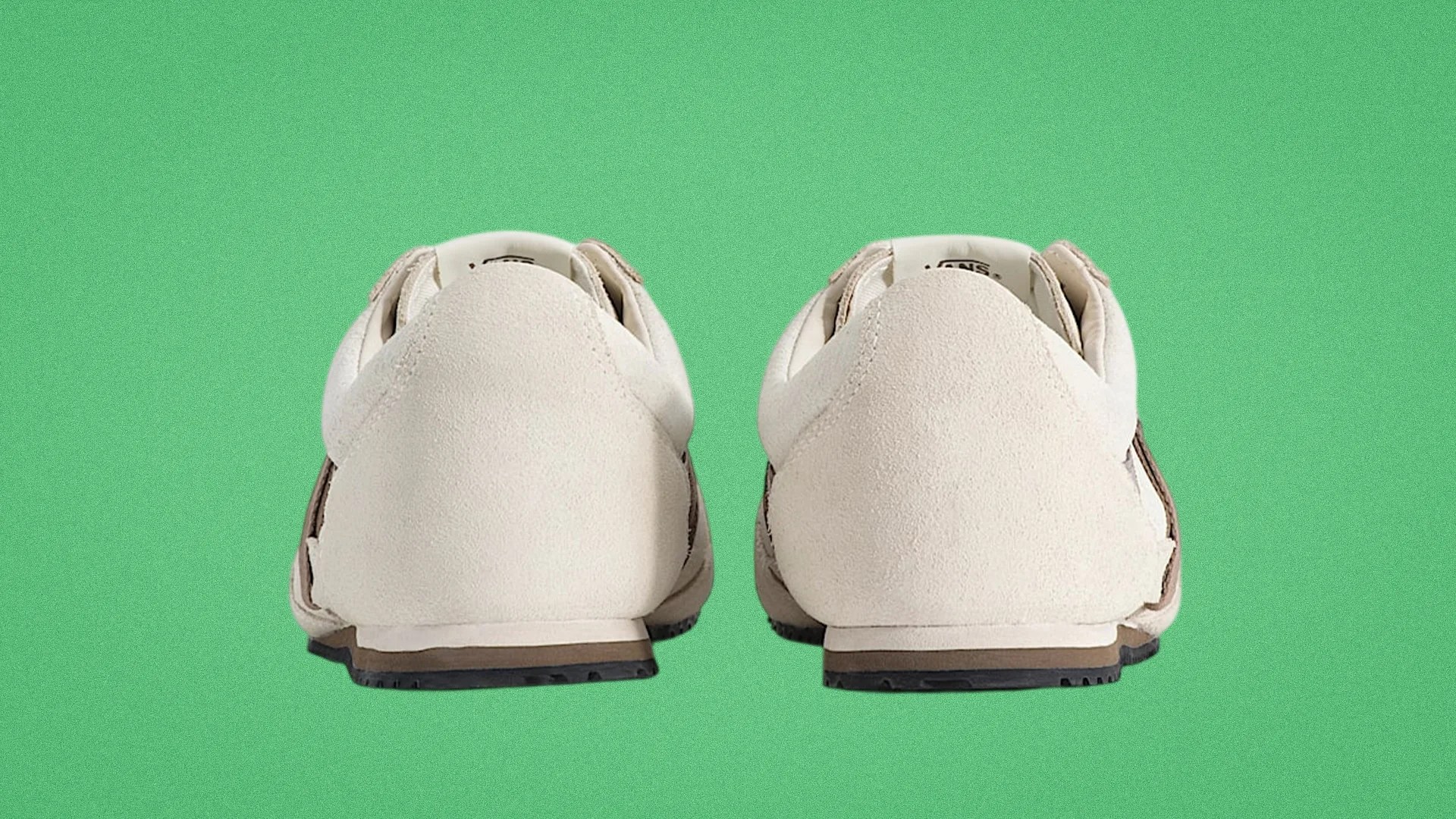 Pair of beige suede sneakers shown from the back on a green background.