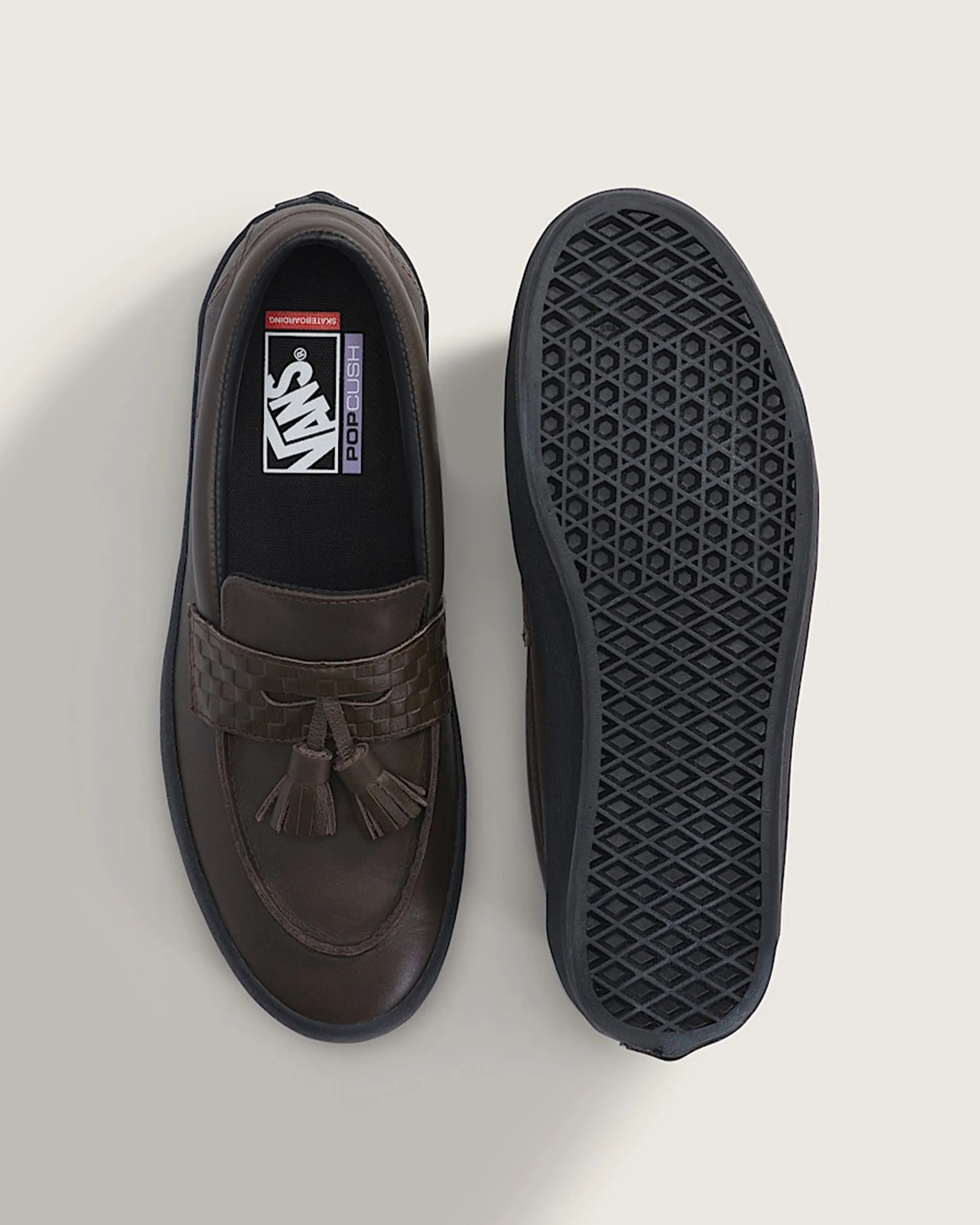 Brown leather Vans loafer with tassels and black waffle sole shown from top and bottom.
