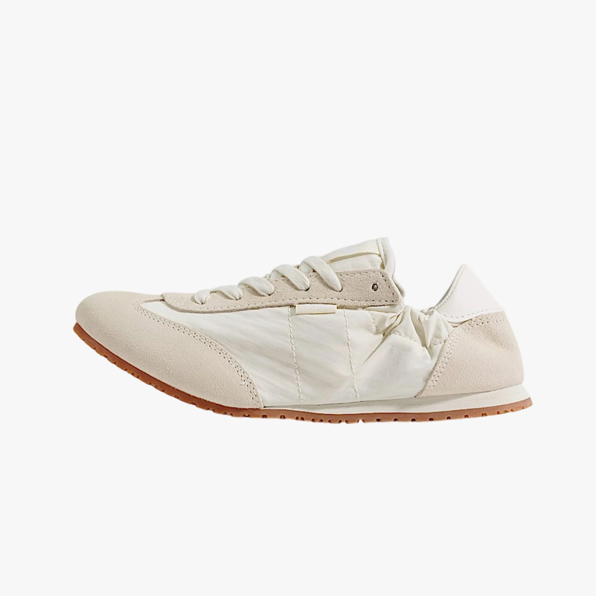 Off-white low-top sneaker with suede overlays and gum rubber sole.