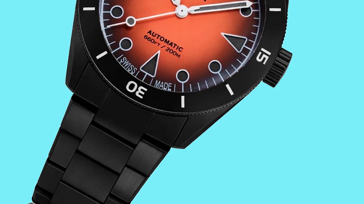 Black metal bracelet watch with orange gradient dial and black bezel on a light blue background.