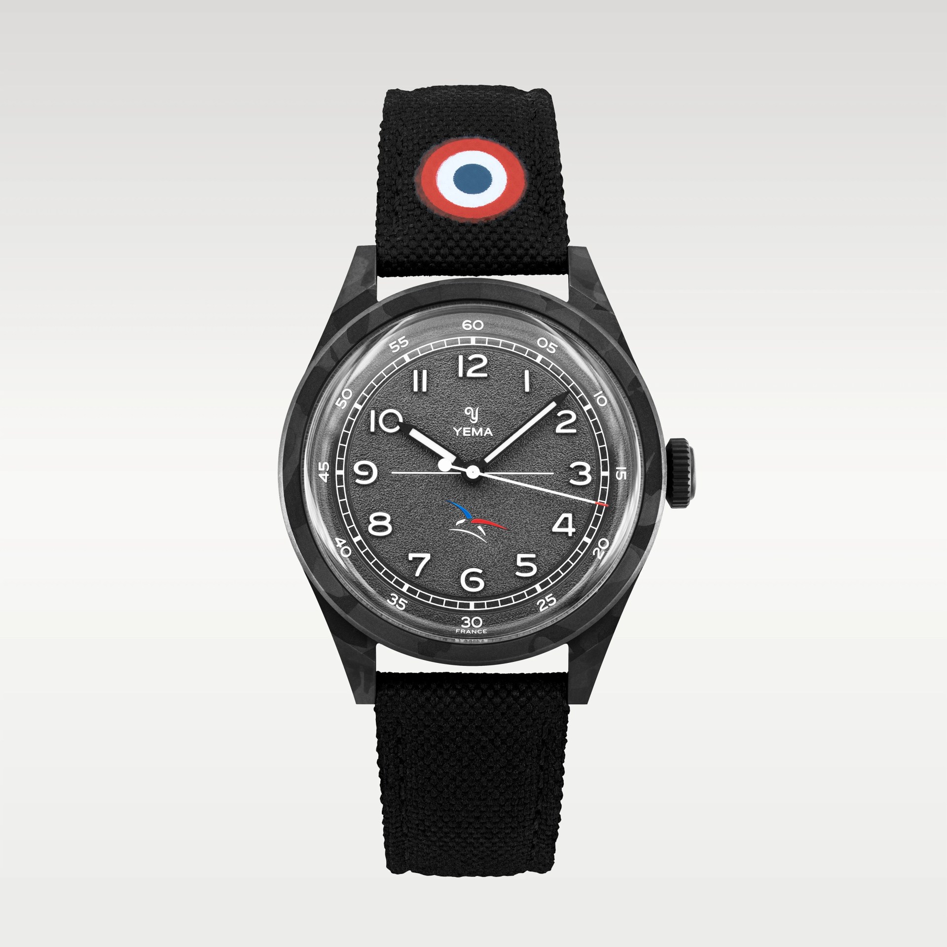 Black textured dial Yema wristwatch with white numerals, black camouflage case, and black fabric strap with red, white, and blue roundel.