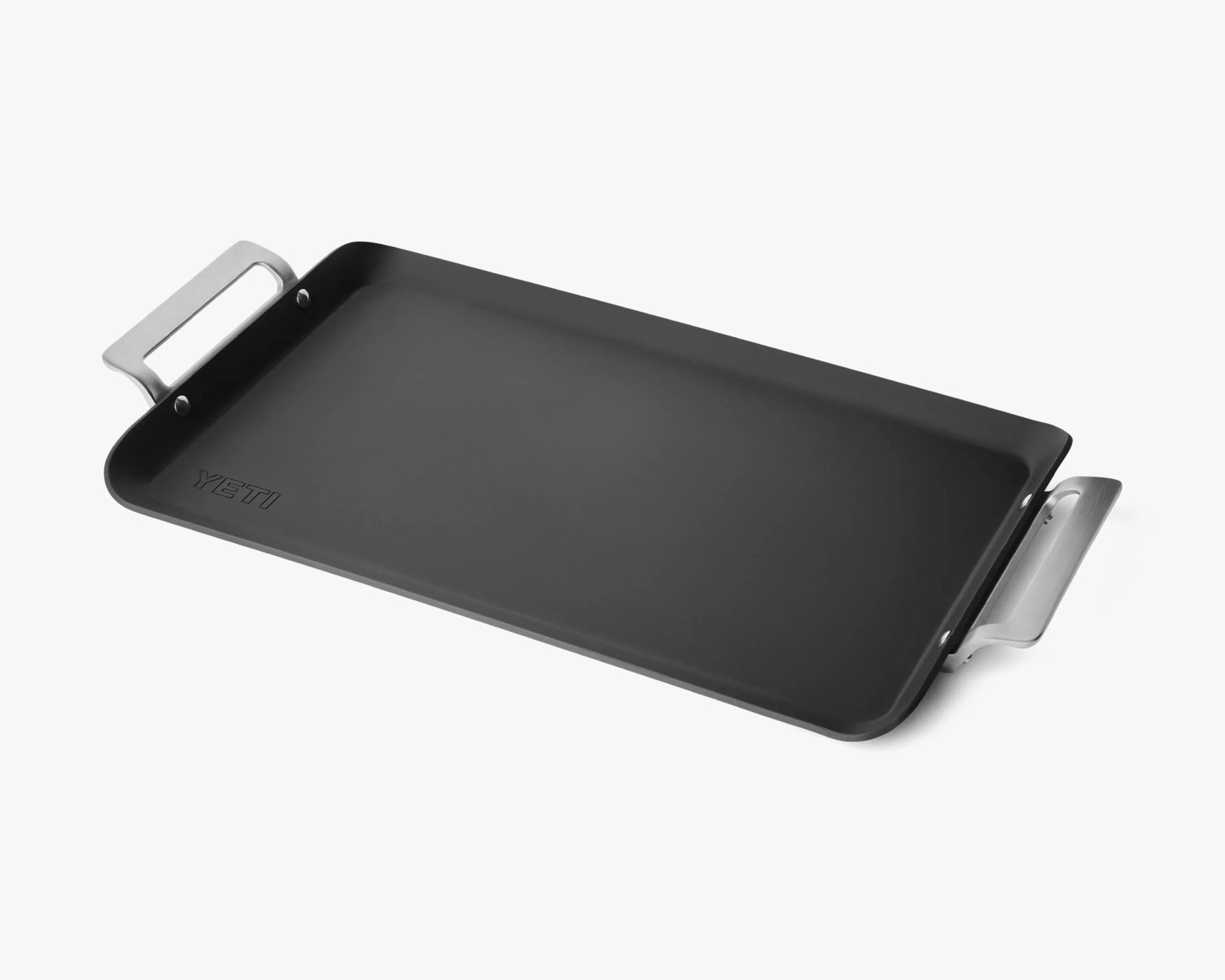 Rectangular black griddle pan with silver handles and YETI logo embossed on the cooking surface.