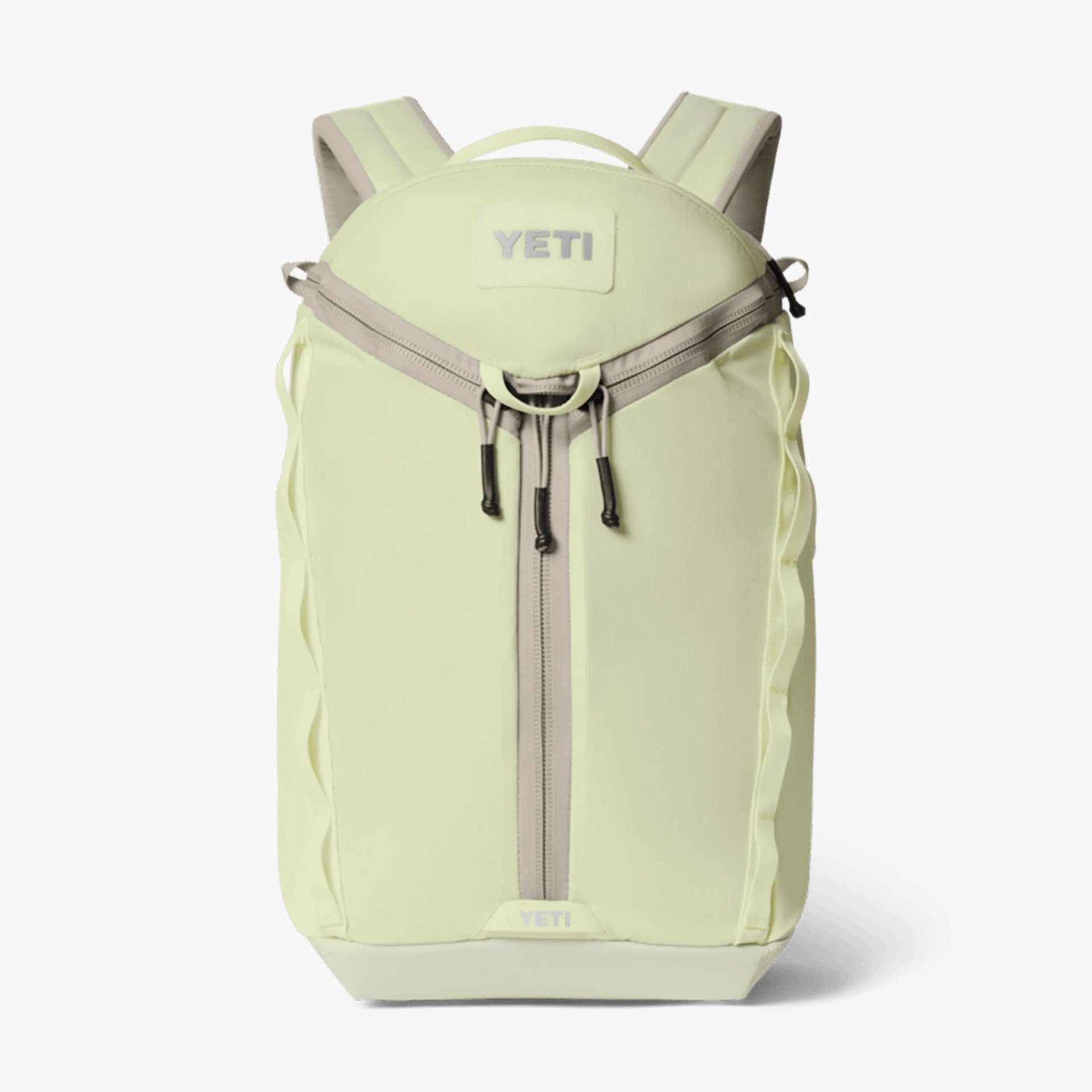 Light yellow YETI backpack with beige zipper and padded shoulder straps on a white background.