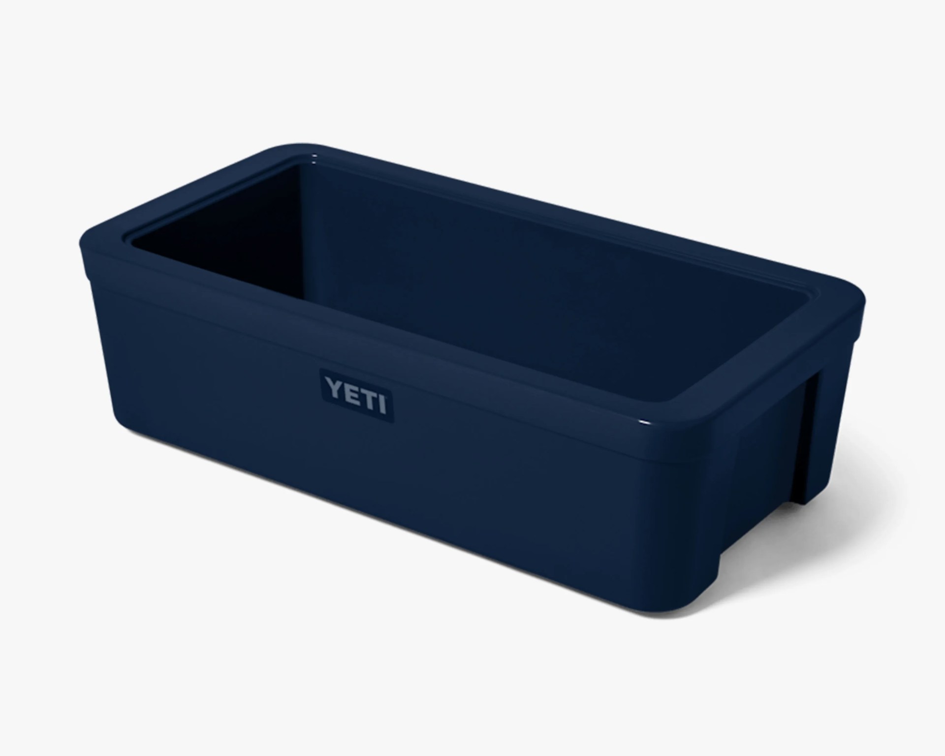 Navy blue rectangular YETI cooler with an open top and smooth finish.