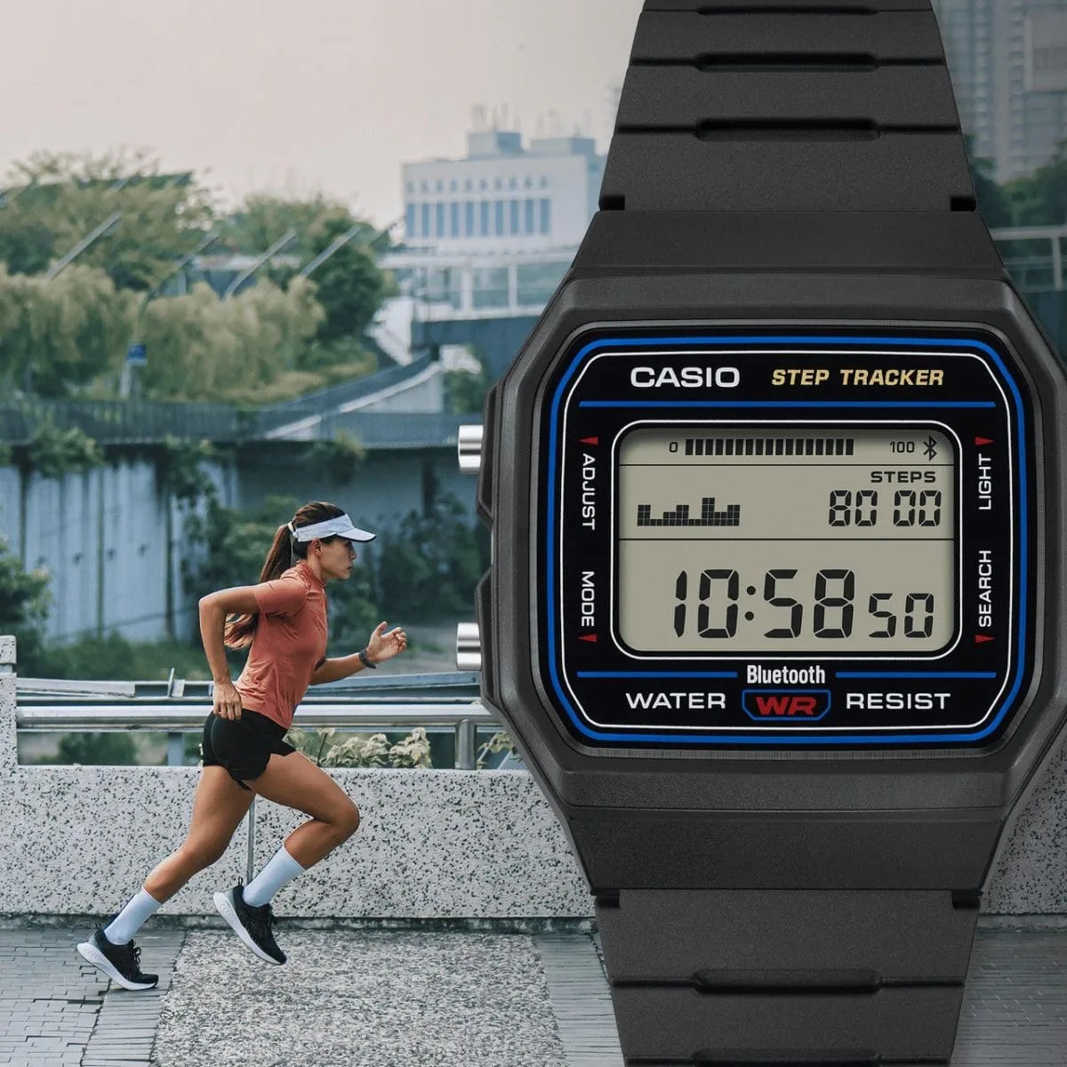 Black Casio digital step tracker watch with blue accents showing time and steps, worn by a runner outdoors.