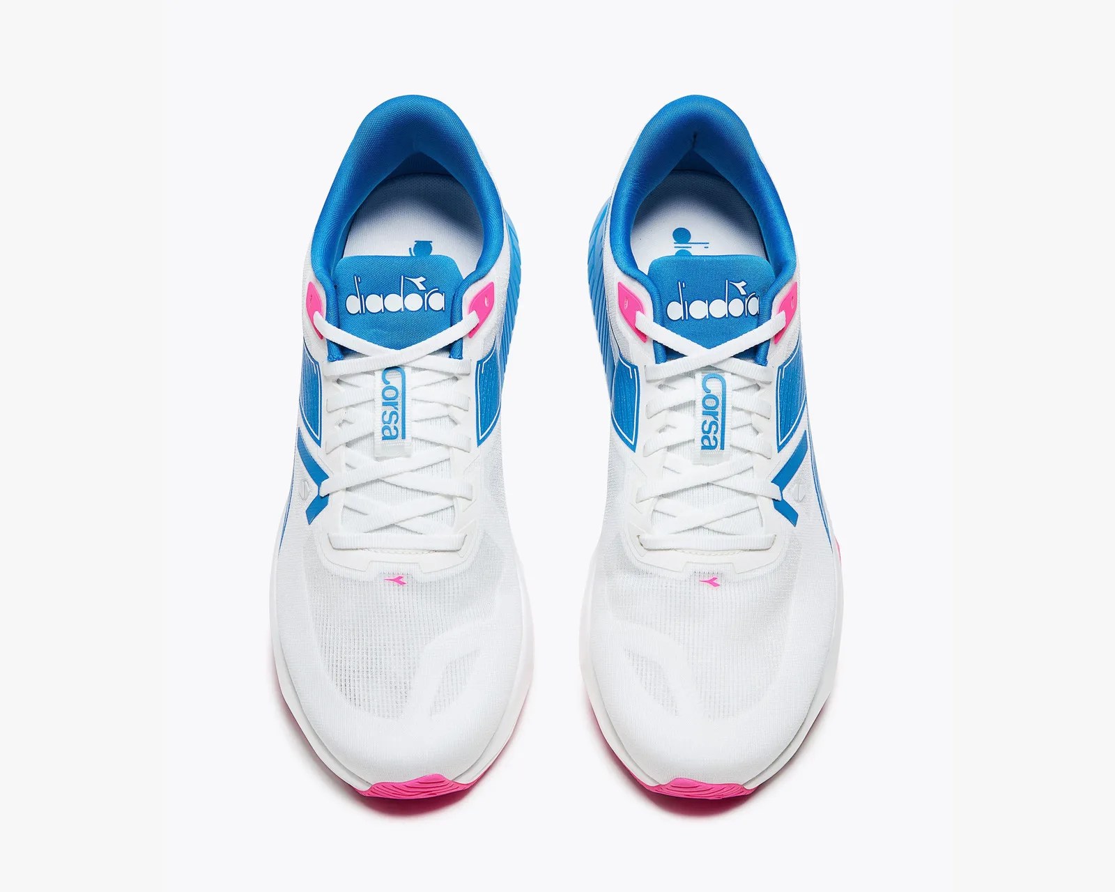 Pair of white Diadora Corsa running shoes with blue accents and pink details, viewed from above.