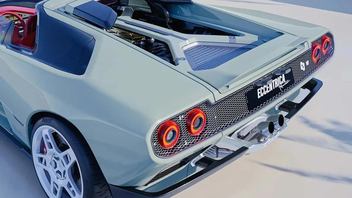 Rear view of a light green sports car with red circular taillights, white wheels, and a black license plate reading "ECCENTRICA.