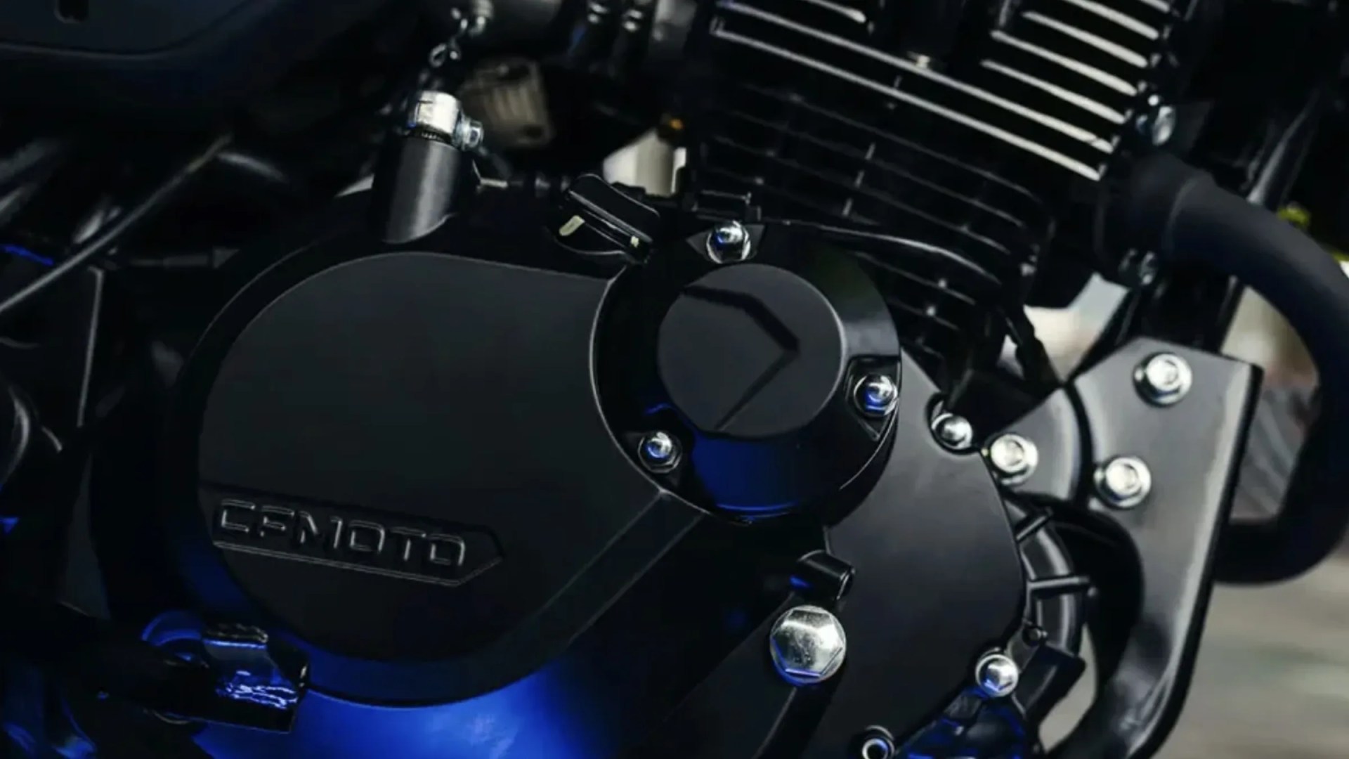 Close-up of a black CFMOTO motorcycle engine with visible bolts and cooling fins.