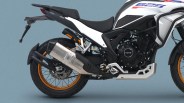 White and black adventure motorcycle with orange spoked wheels and large silver exhaust on a blue background.