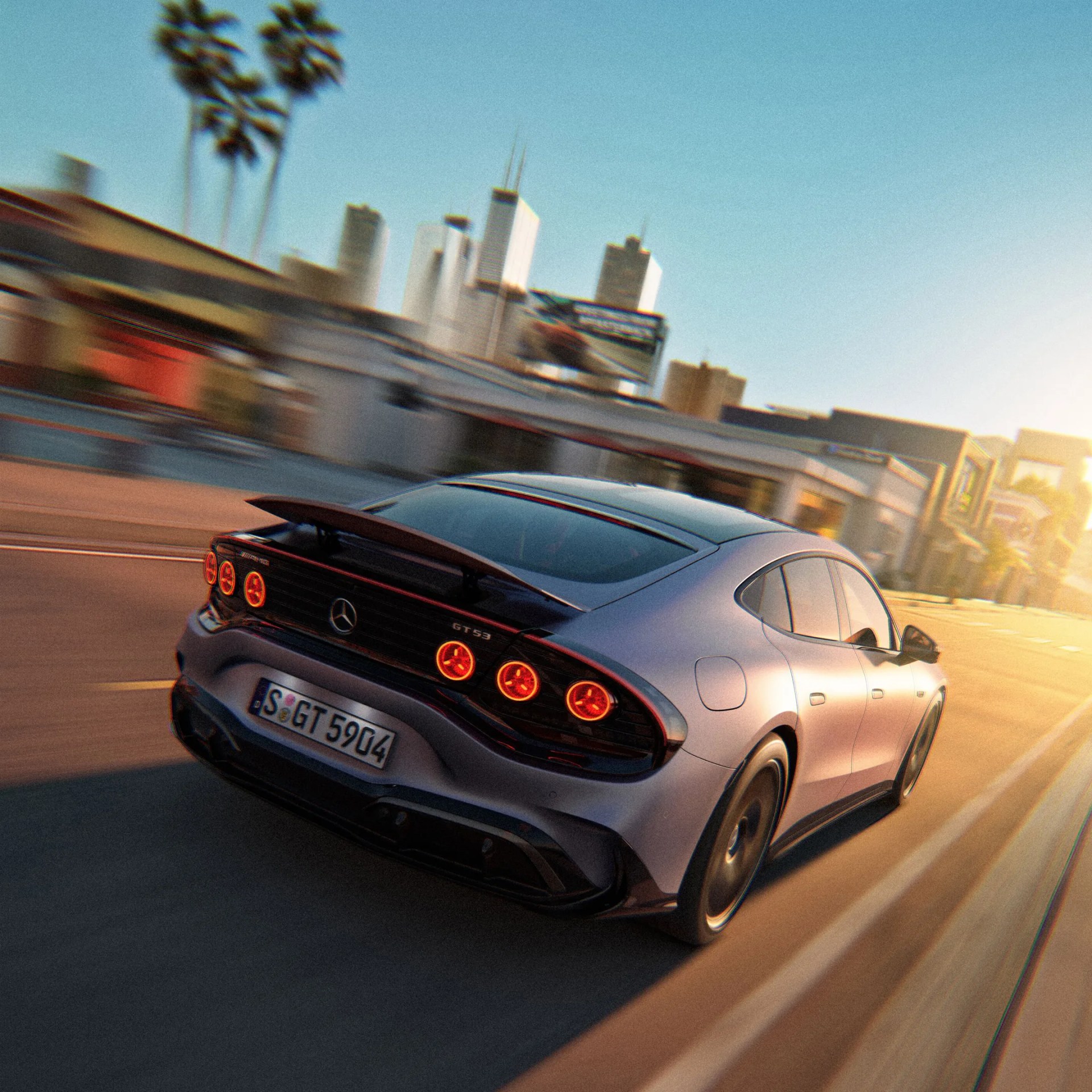 Silver Mercedes-Benz GT 53 with illuminated round taillights driving on a city street at sunset.