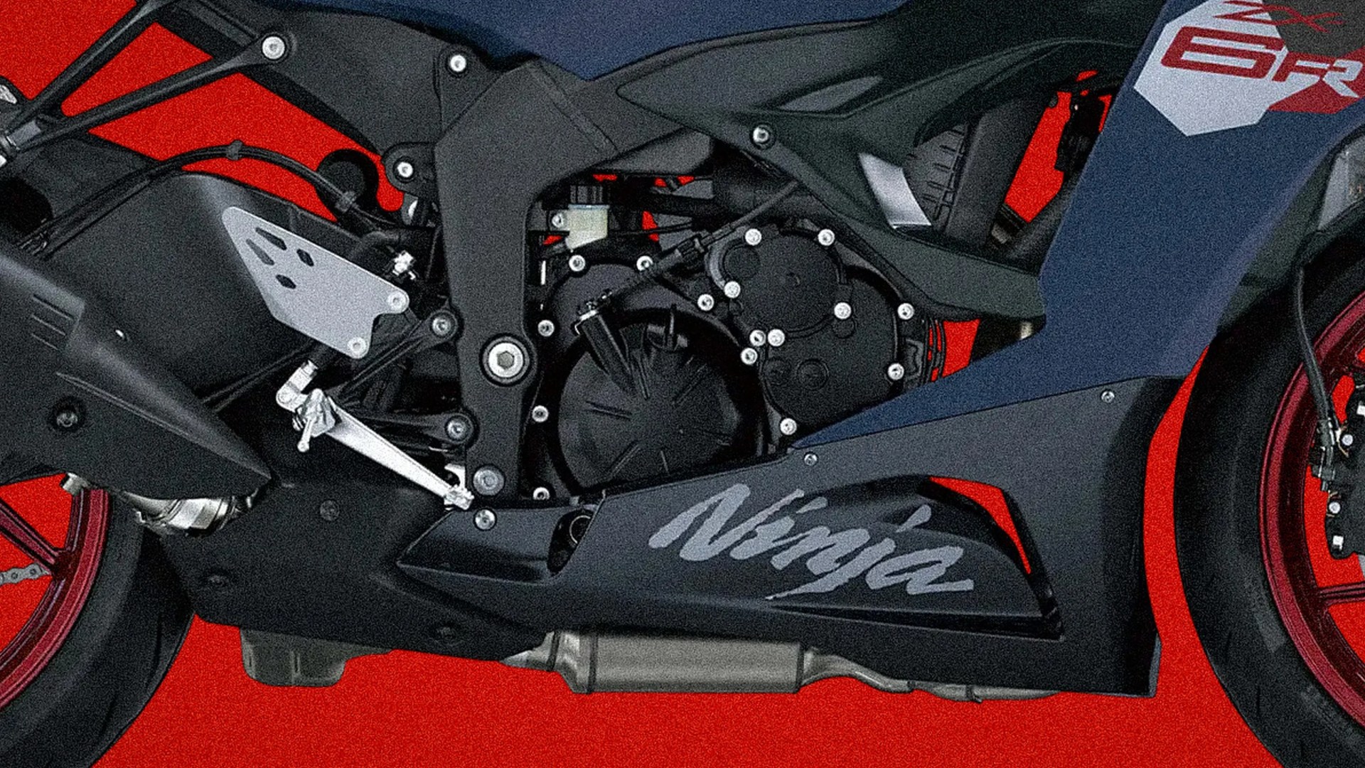 Close-up of a black Kawasaki Ninja motorcycle engine and frame with red wheels against a red background.