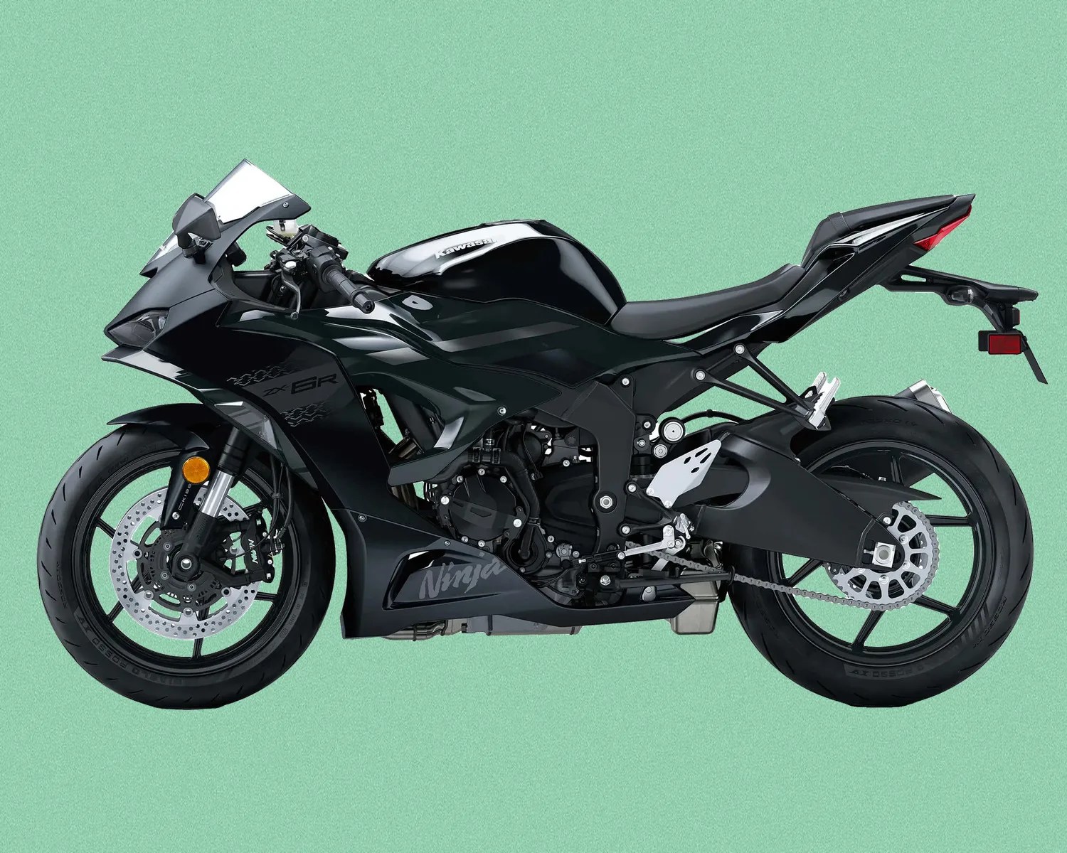 Black Kawasaki Ninja ZX-6R sport motorcycle with full fairing on a green background.
