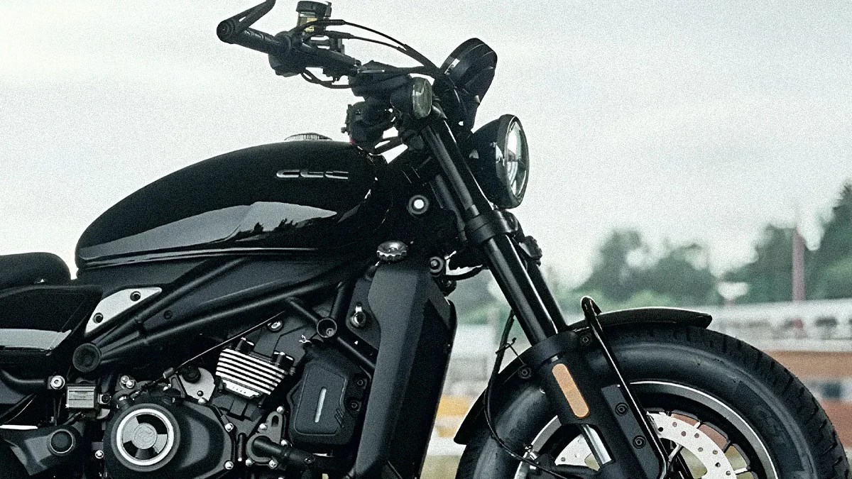 Black motorcycle front and side view showing the fuel tank, headlight, and front tire.