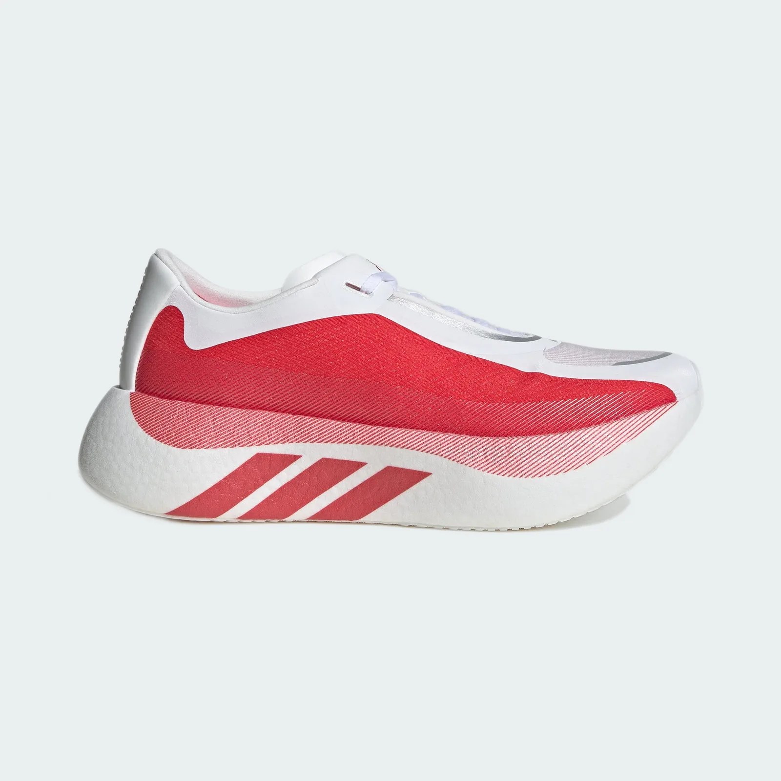 White and red athletic shoe with thick sole and three red stripes on the side.