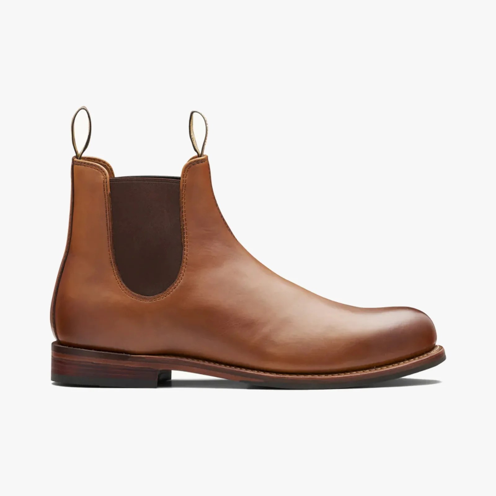 Brown leather Chelsea boot with dark elastic side panels and pull tabs on a white background.
