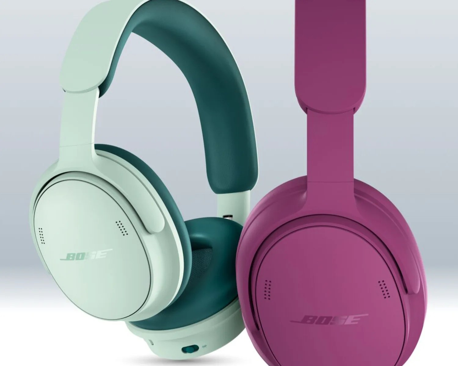Two Bose over-ear headphones, one in mint green and teal and the other in magenta, shown against a light background.