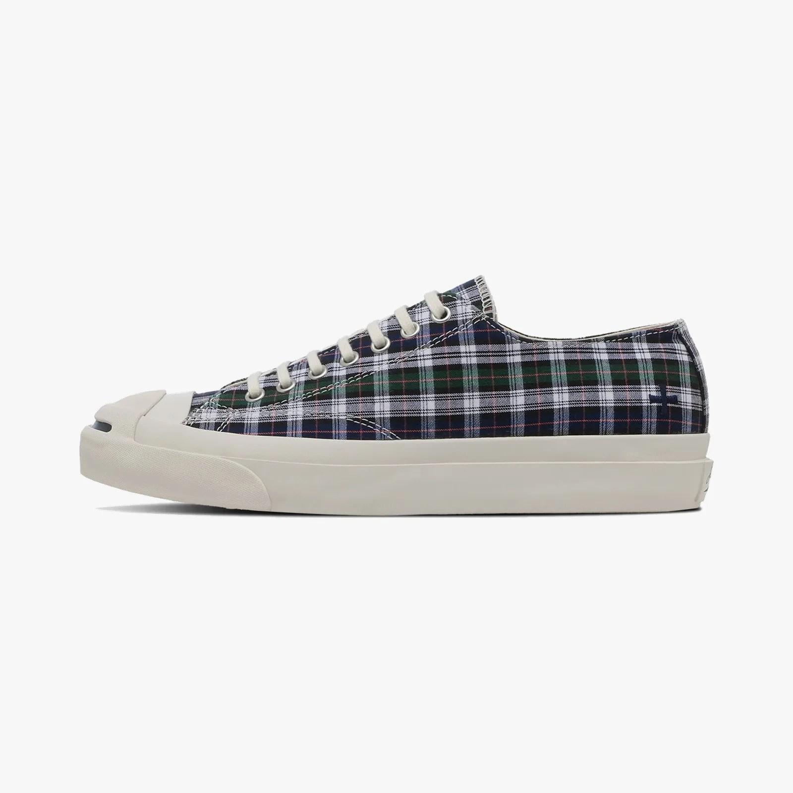 Low-top sneaker with green, navy, and white plaid fabric upper and off-white rubber sole and toe cap.
