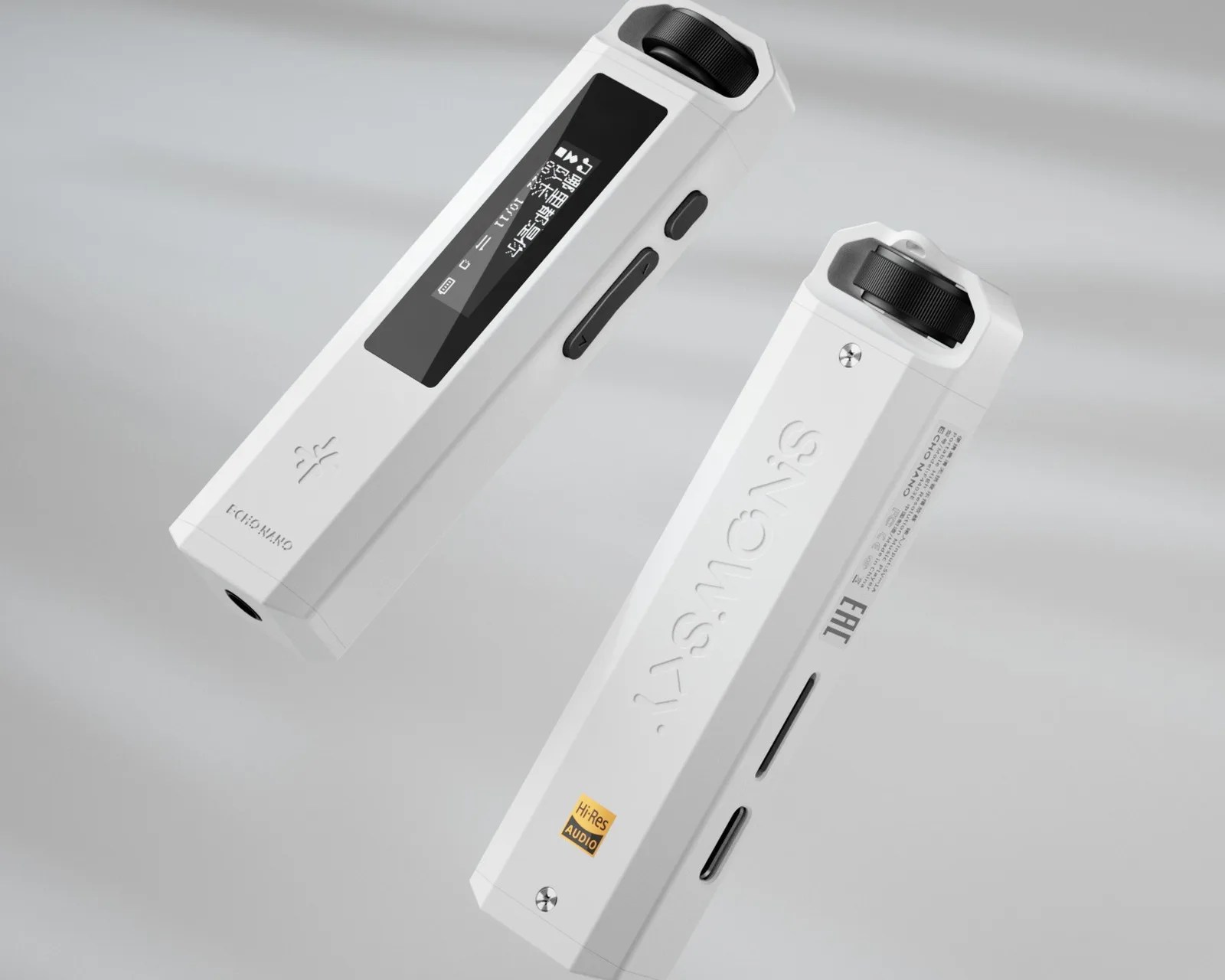 Two white rectangular digital audio players with black control wheels and display screens floating on a light gray background.