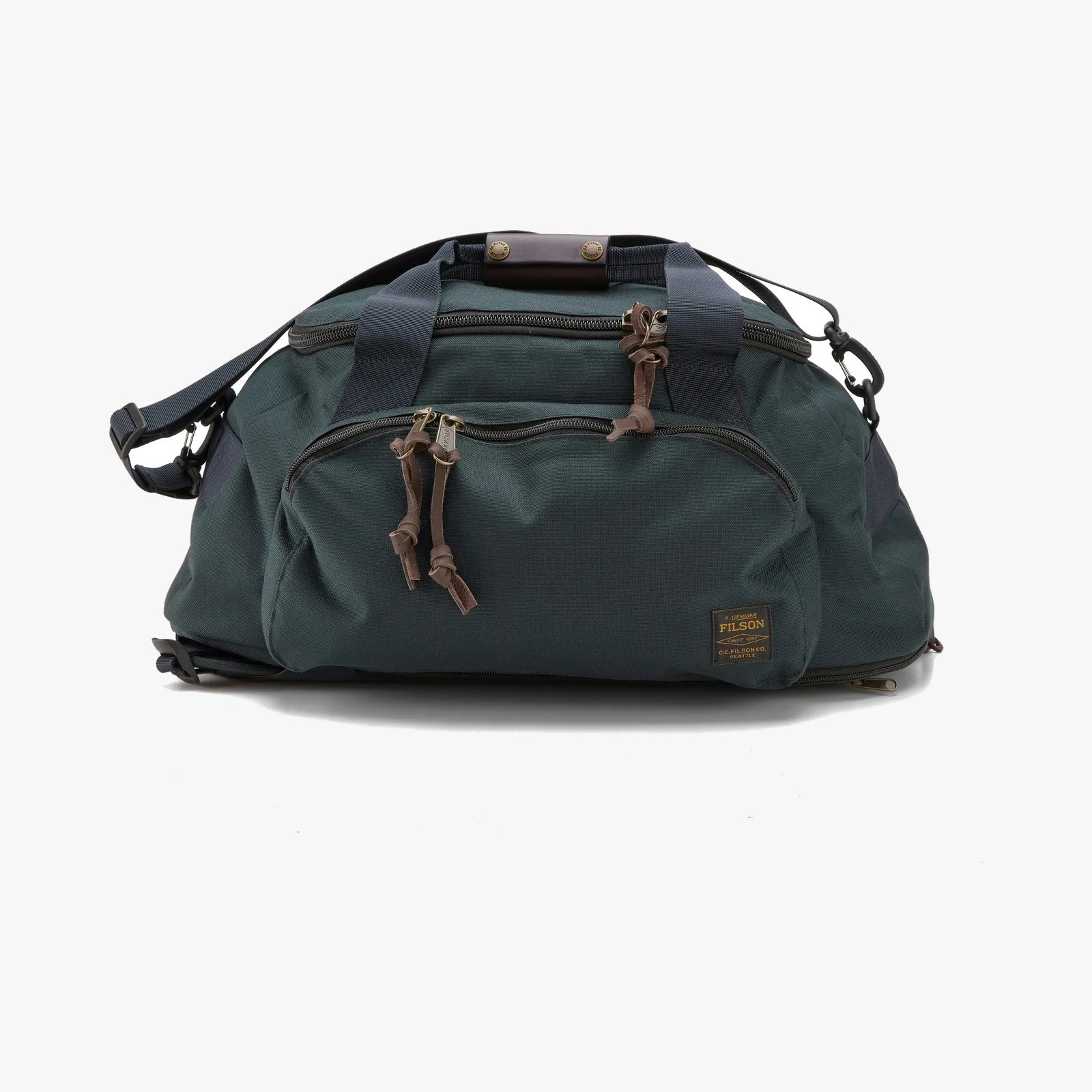 Dark green canvas duffel bag with black straps and leather zipper pulls, featuring a front zip pocket and Filson logo patch.