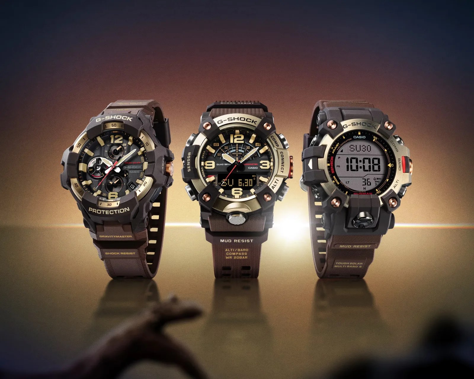 Three brown and black Casio G-Shock watches with analog and digital displays on a reflective surface with a gradient background.
