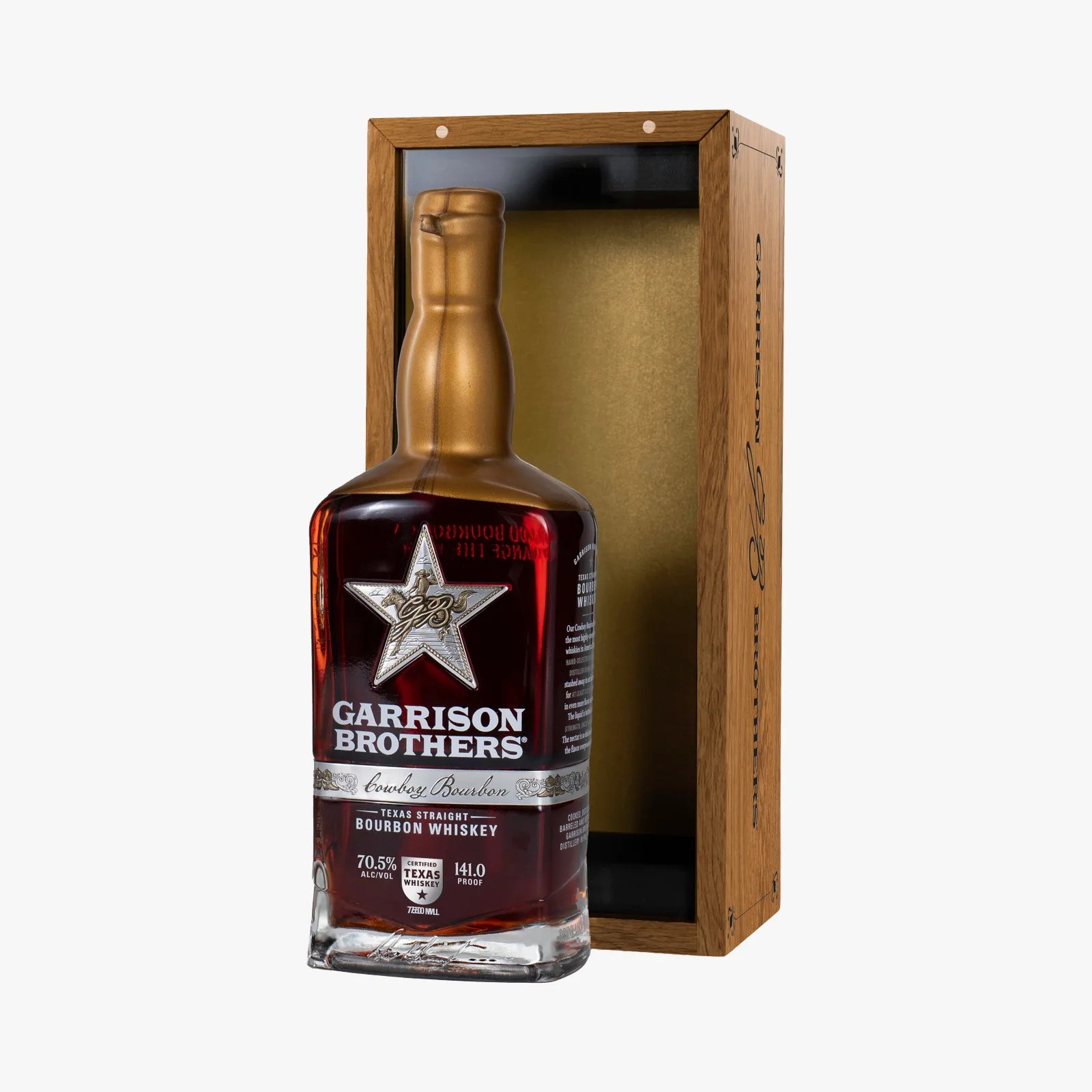 Bottle of Garrison Brothers Cowboy Bourbon Texas Straight Bourbon Whiskey with gold foil top and wooden display box.