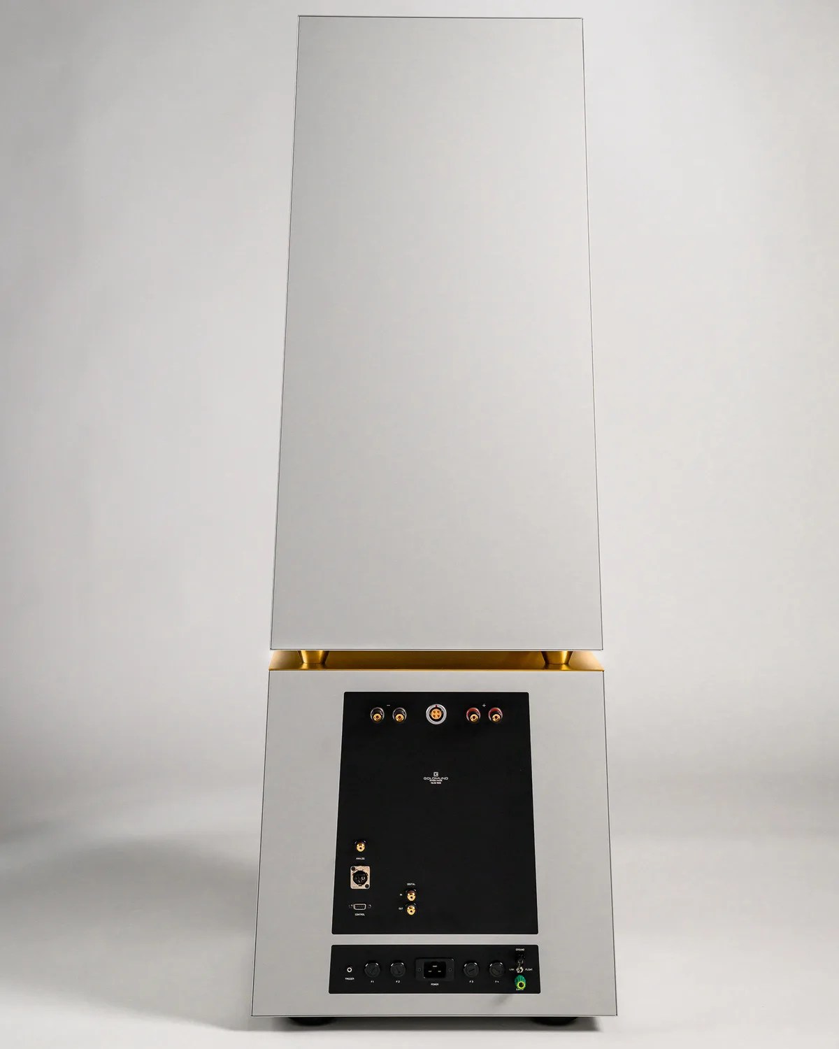 Tall white speaker with gold accents and black control panel on the back.