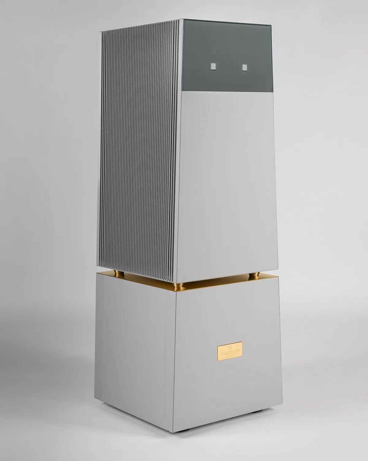 Tall rectangular silver air purifier with vertical vents on one side and a gold accent near the base.