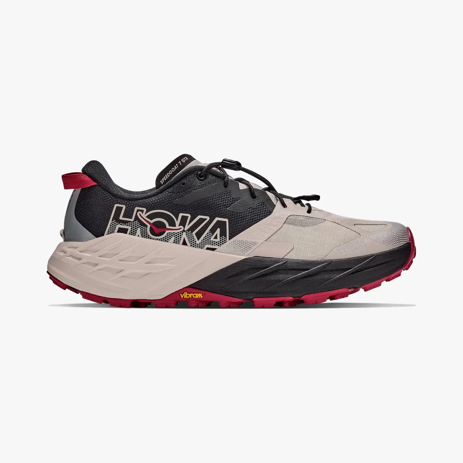 Beige and black Hoka Speedgoat 7 GTX trail running shoe with red outsole and Vibram logo.