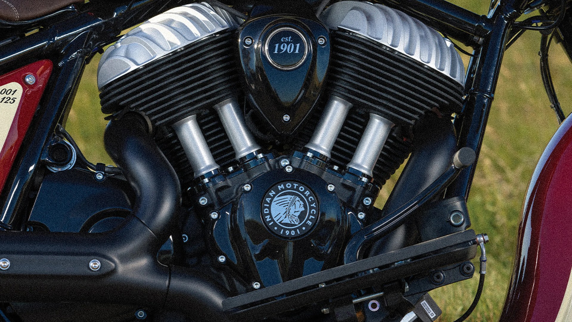 Close-up of a black and silver Indian Motorcycle engine with "est. 1901" and Indian Motorcycle logo visible.