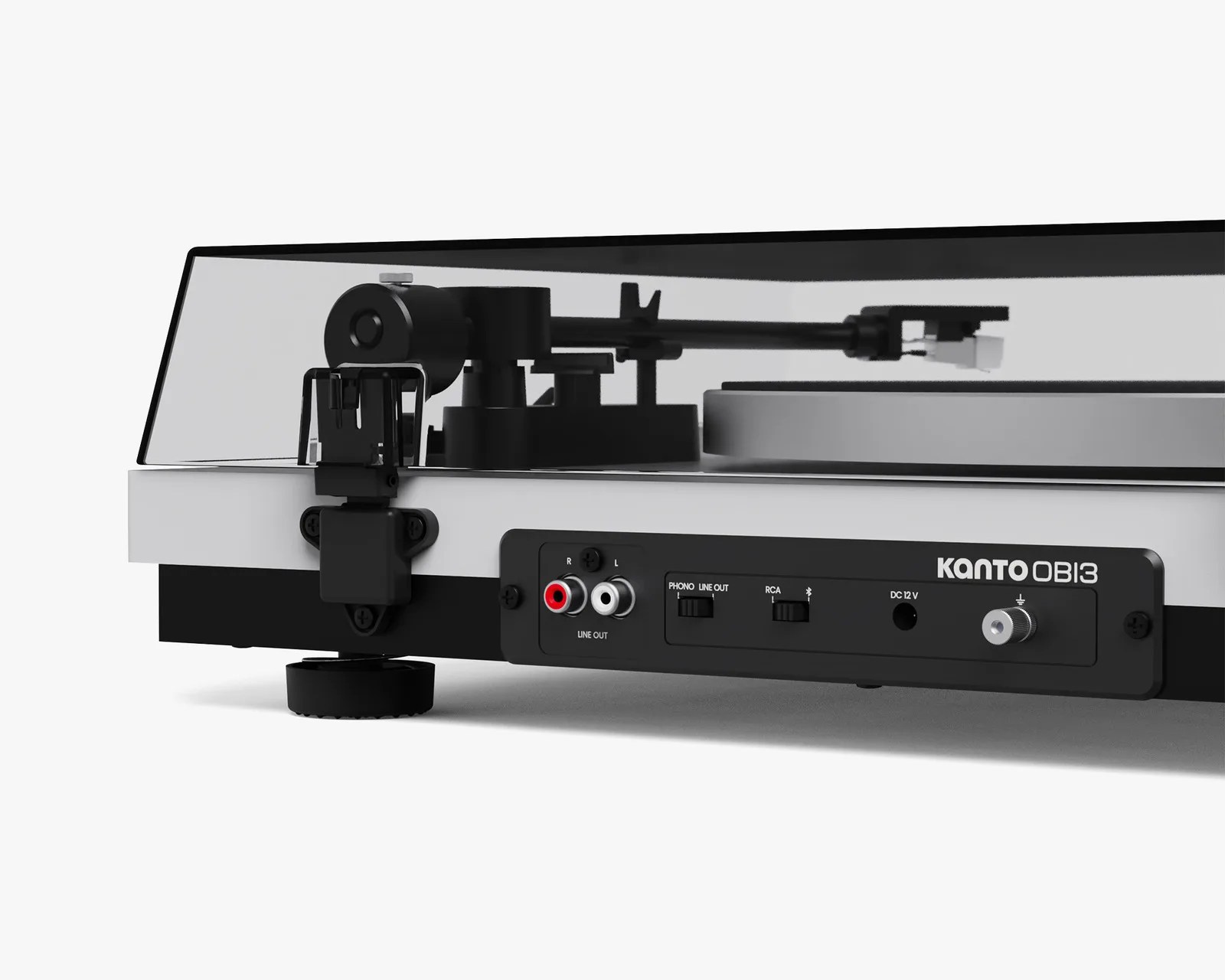 Close-up of the back panel of a Kanto OBI3 turntable showing RCA line out ports, switches, and a dust cover.
