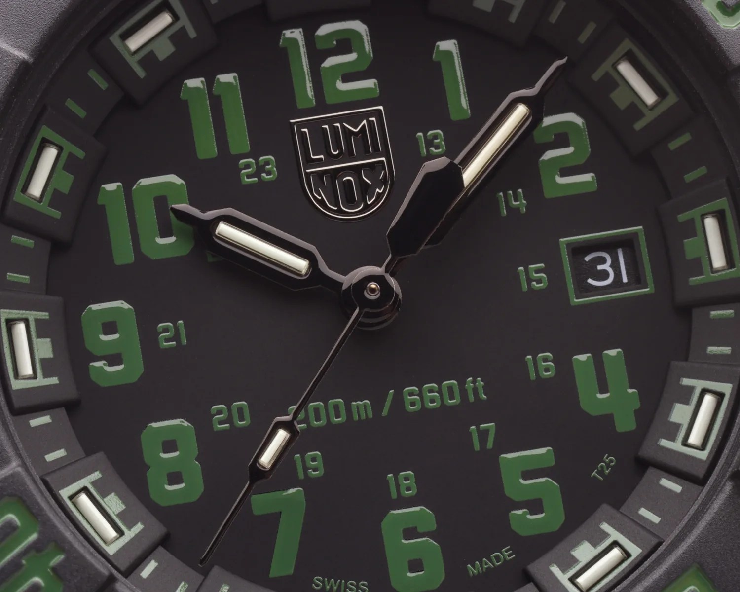 Close-up of a black Luminox watch face with green numerals, white luminescent hands, and a date window showing "31".
