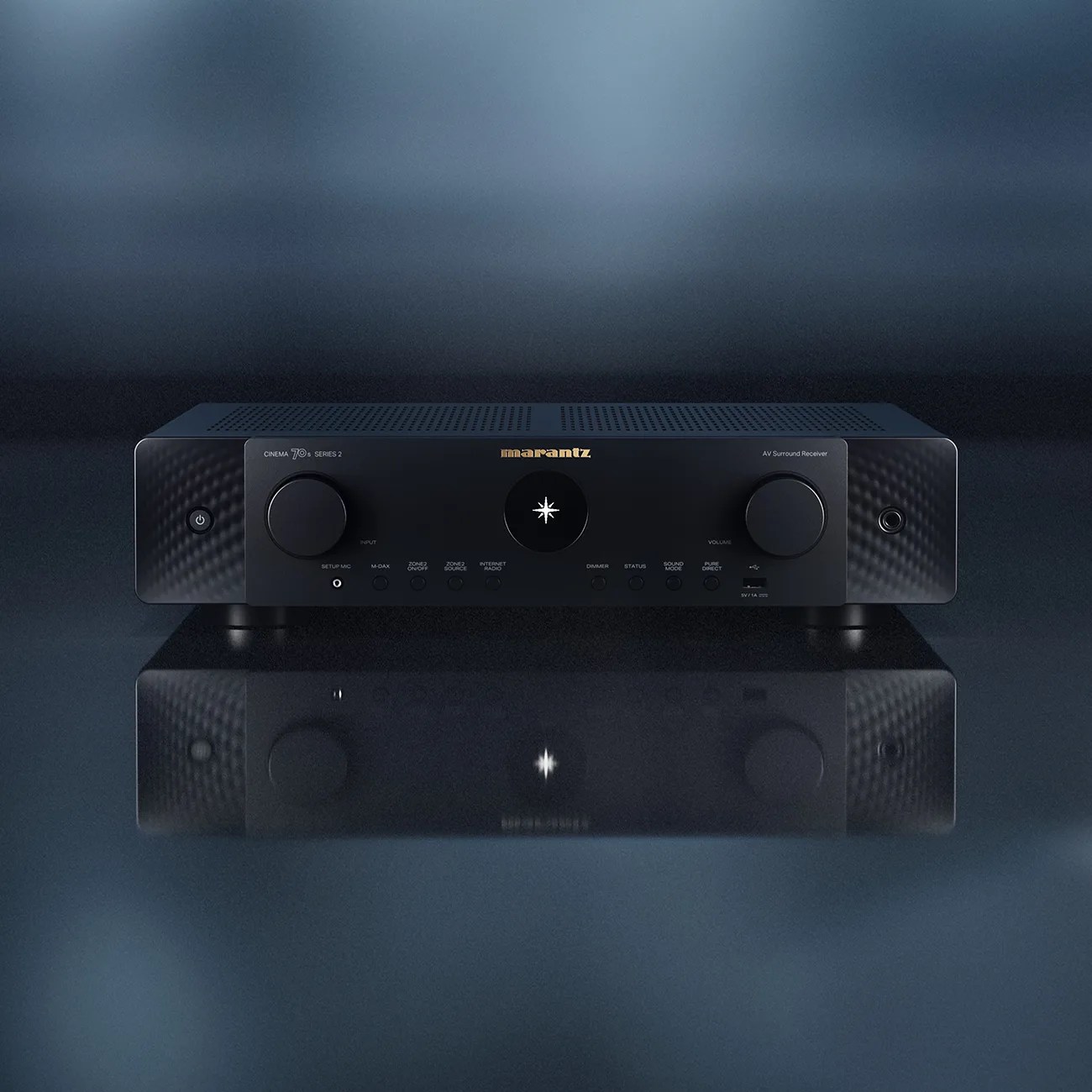 Black Marantz Cinema 70s Series 2 AV surround receiver with knobs and buttons on a reflective surface.