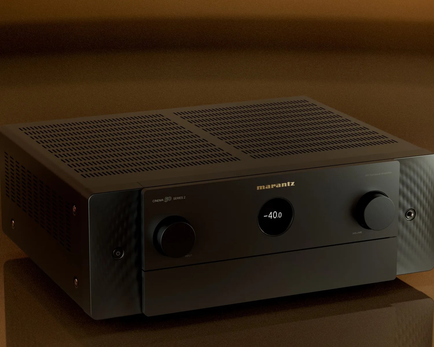 Black Marantz Cinema 50 Series 2 AV surround amplifier with digital display and control knobs on a brown surface.