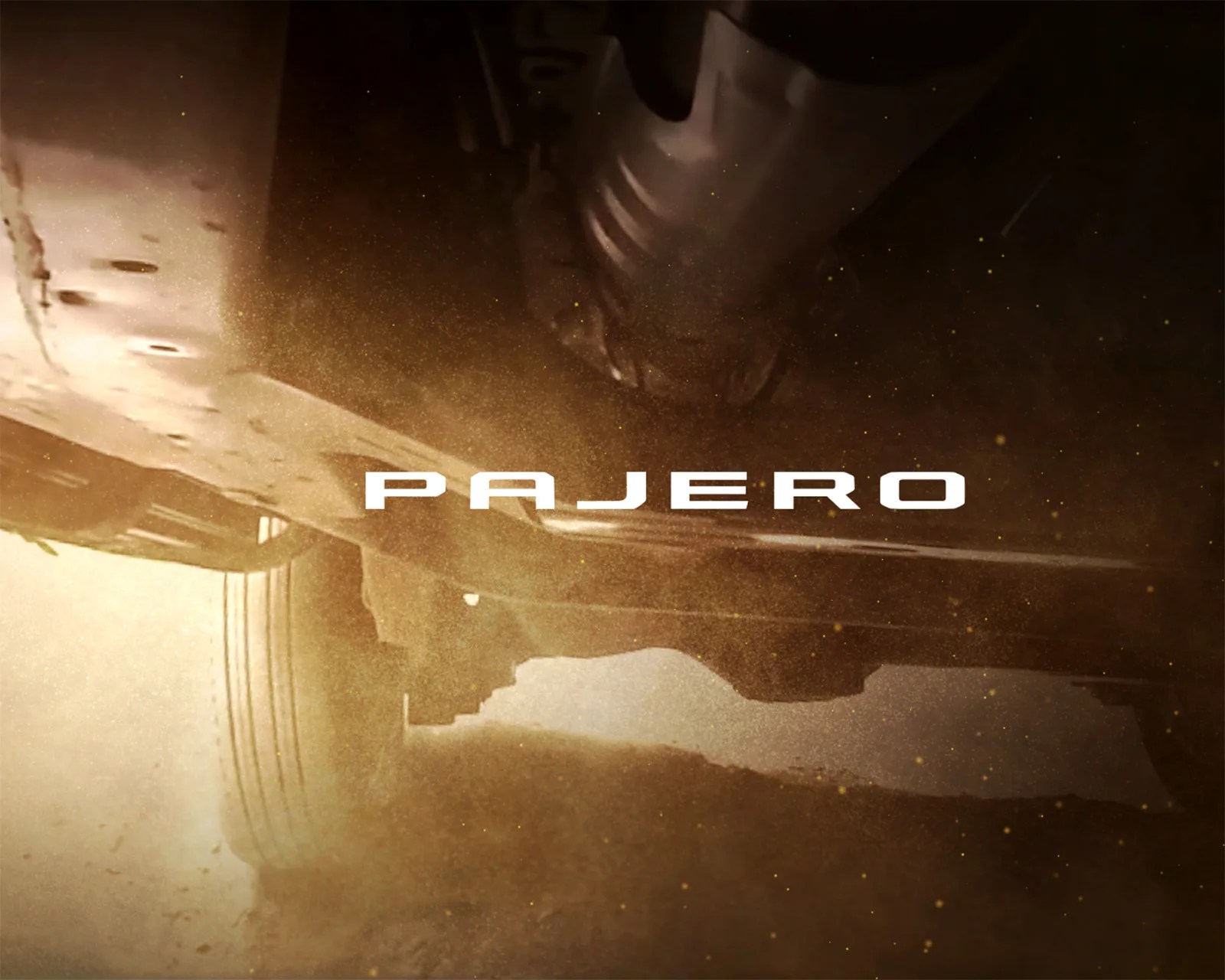 Underside of a vehicle kicking up dust with the word "PAJERO" overlaid in white text.