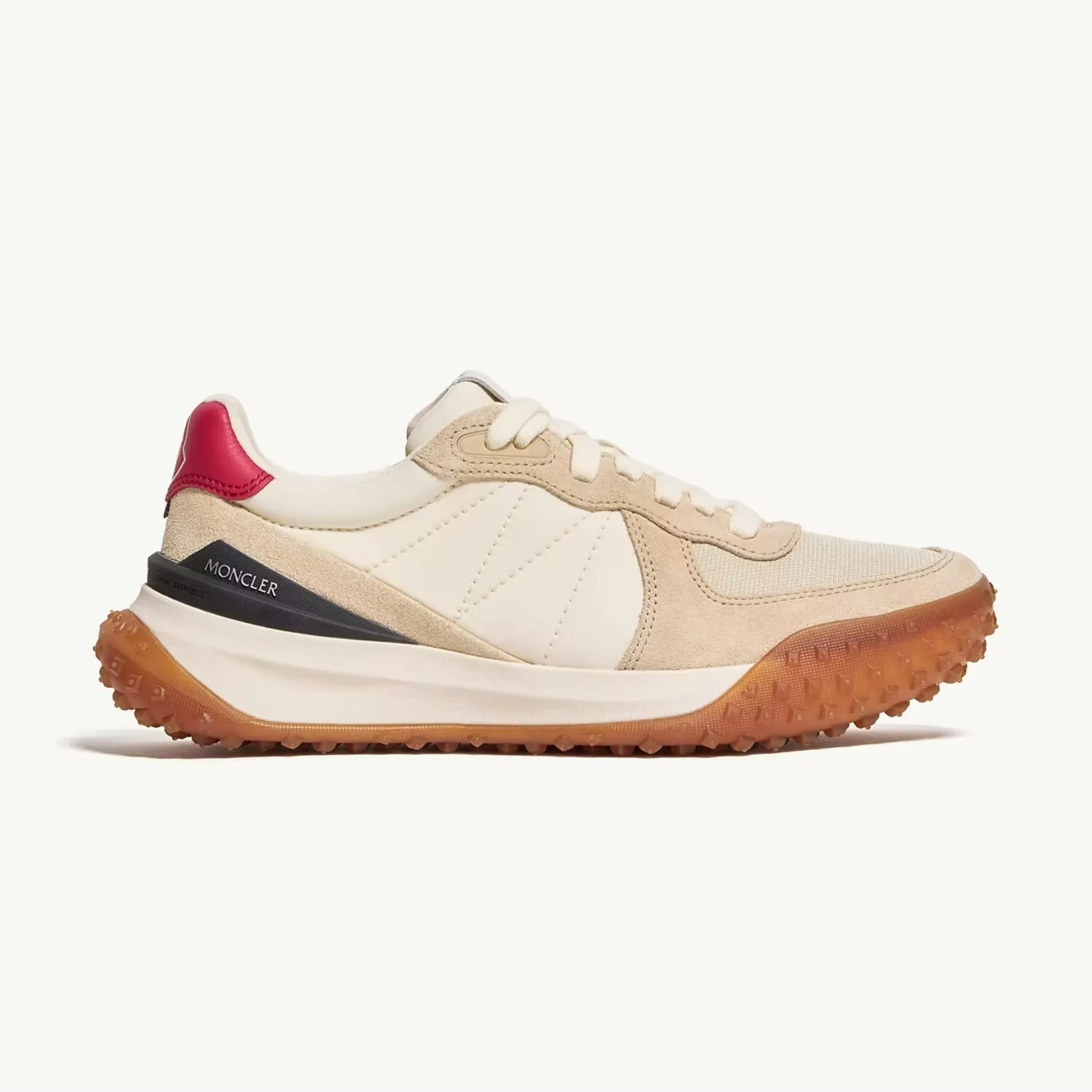 Beige and cream Moncler sneaker with red heel tab and gum sole.