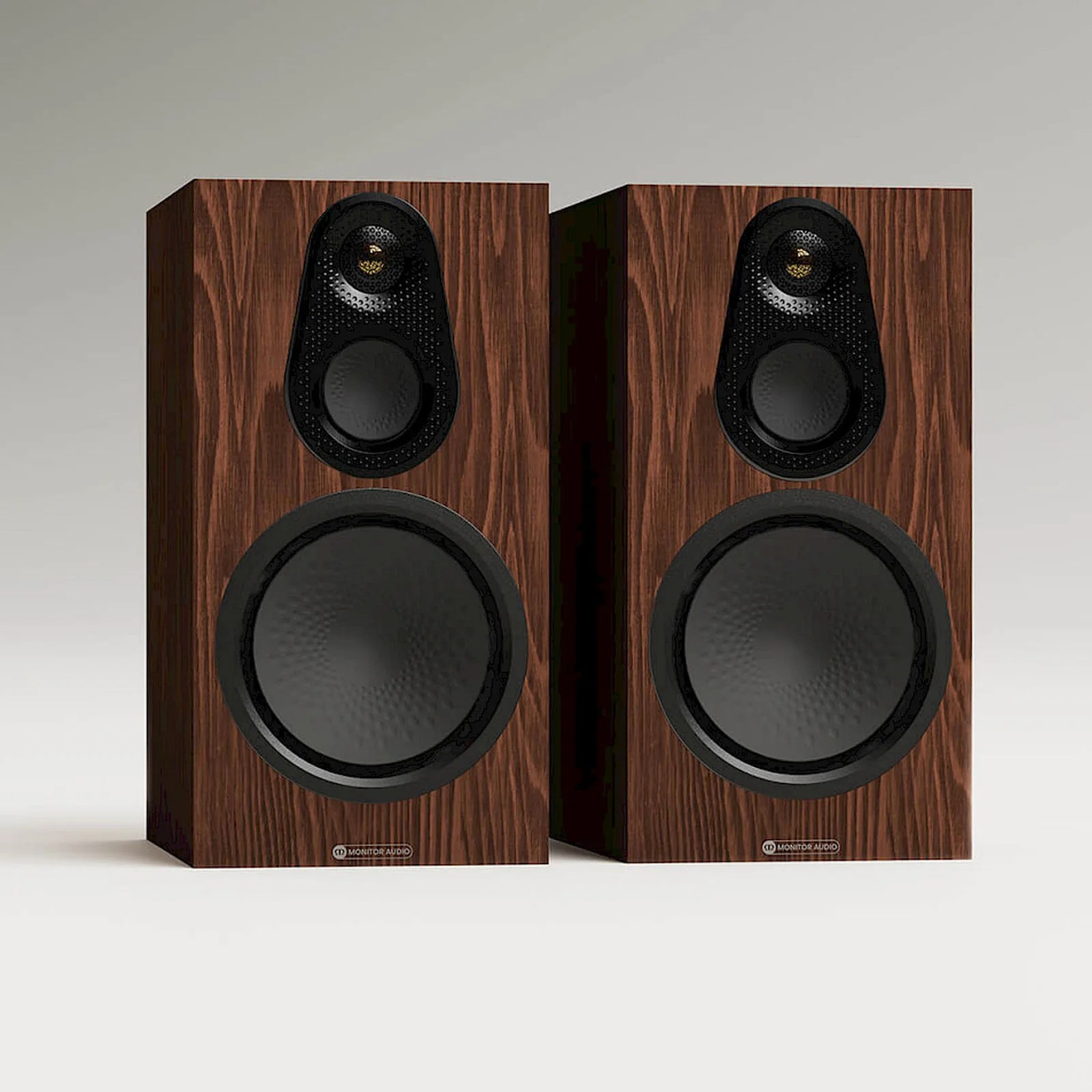 Pair of Monitor Audio speakers with dark wood finish and black speaker cones.