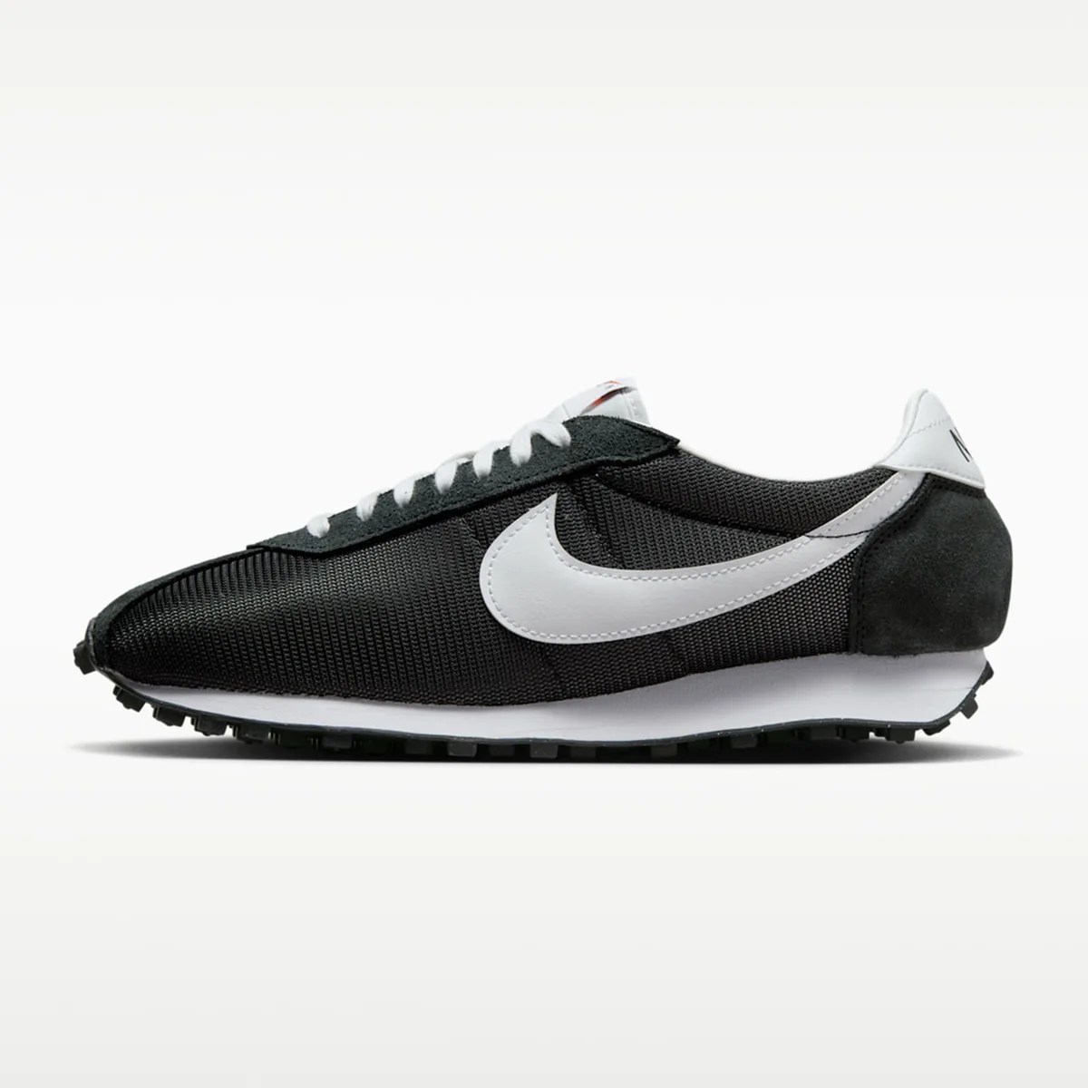 Black and white Nike sneaker with mesh upper and white swoosh logo on side.