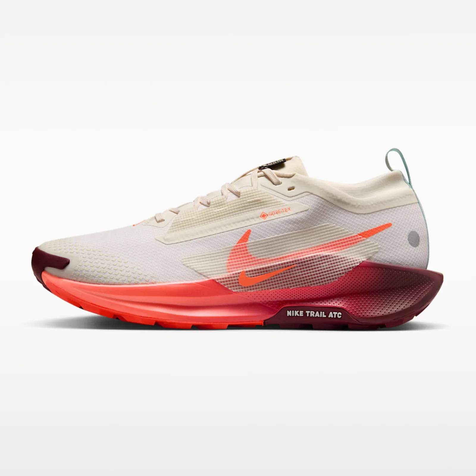 Beige and red Nike Trail ATC running shoe with translucent side panel and Gore-Tex label.