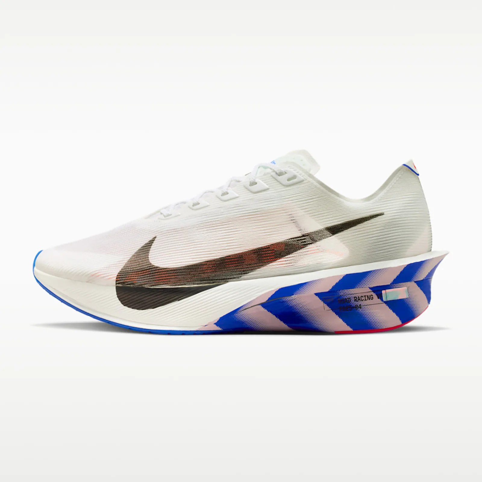 White Nike running shoe with a large black swoosh and a blue and pink patterned sole.