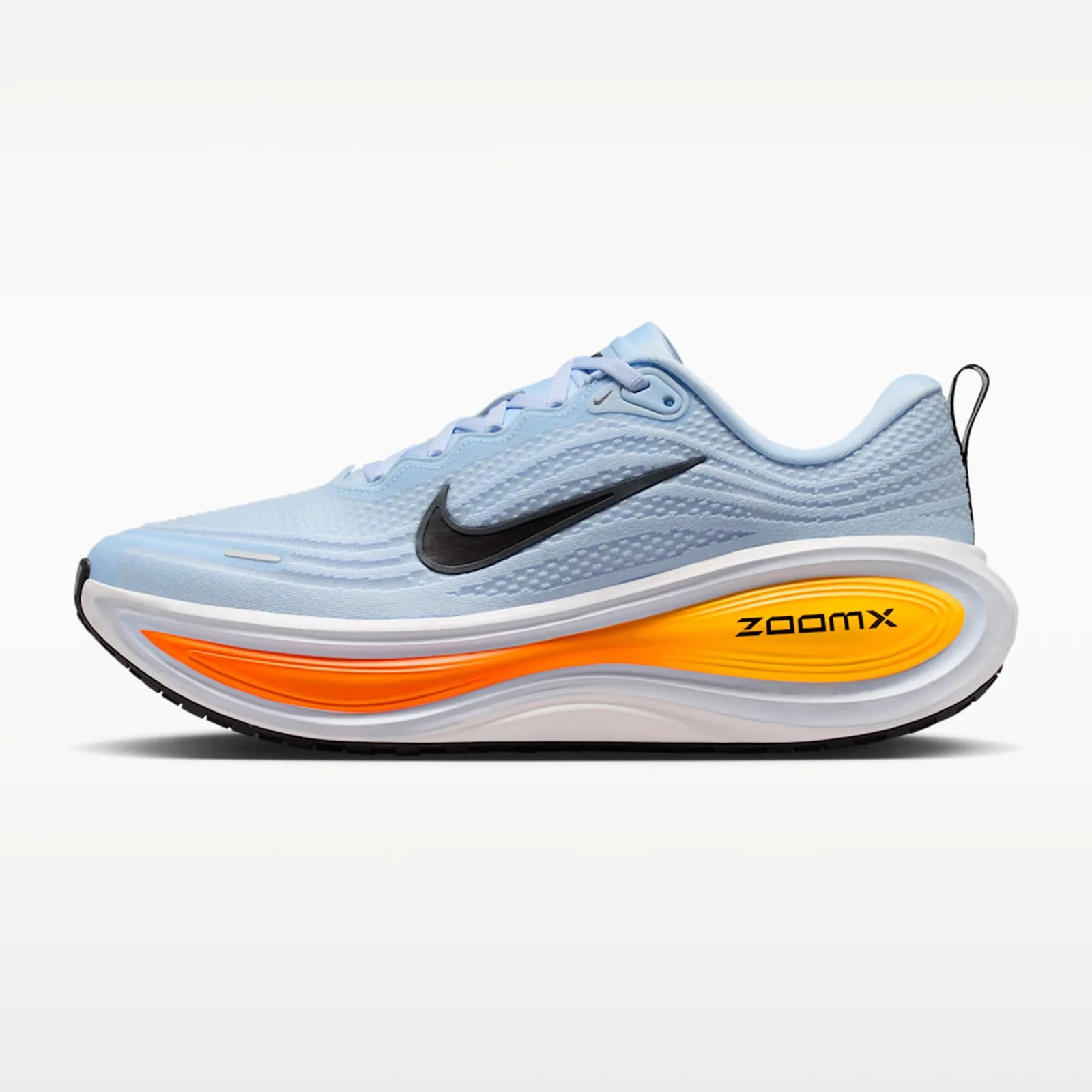 Light blue Nike running shoe with black swoosh logo and orange ZoomX cushioning sole.