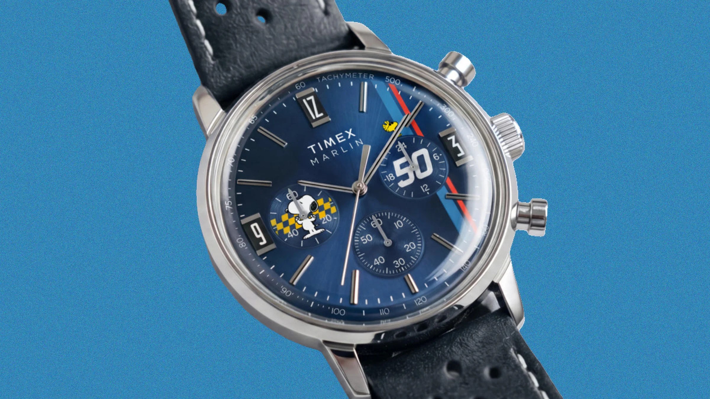 Timex Marlin chronograph watch with blue dial featuring Snoopy and Woodstock illustrations and black leather strap.