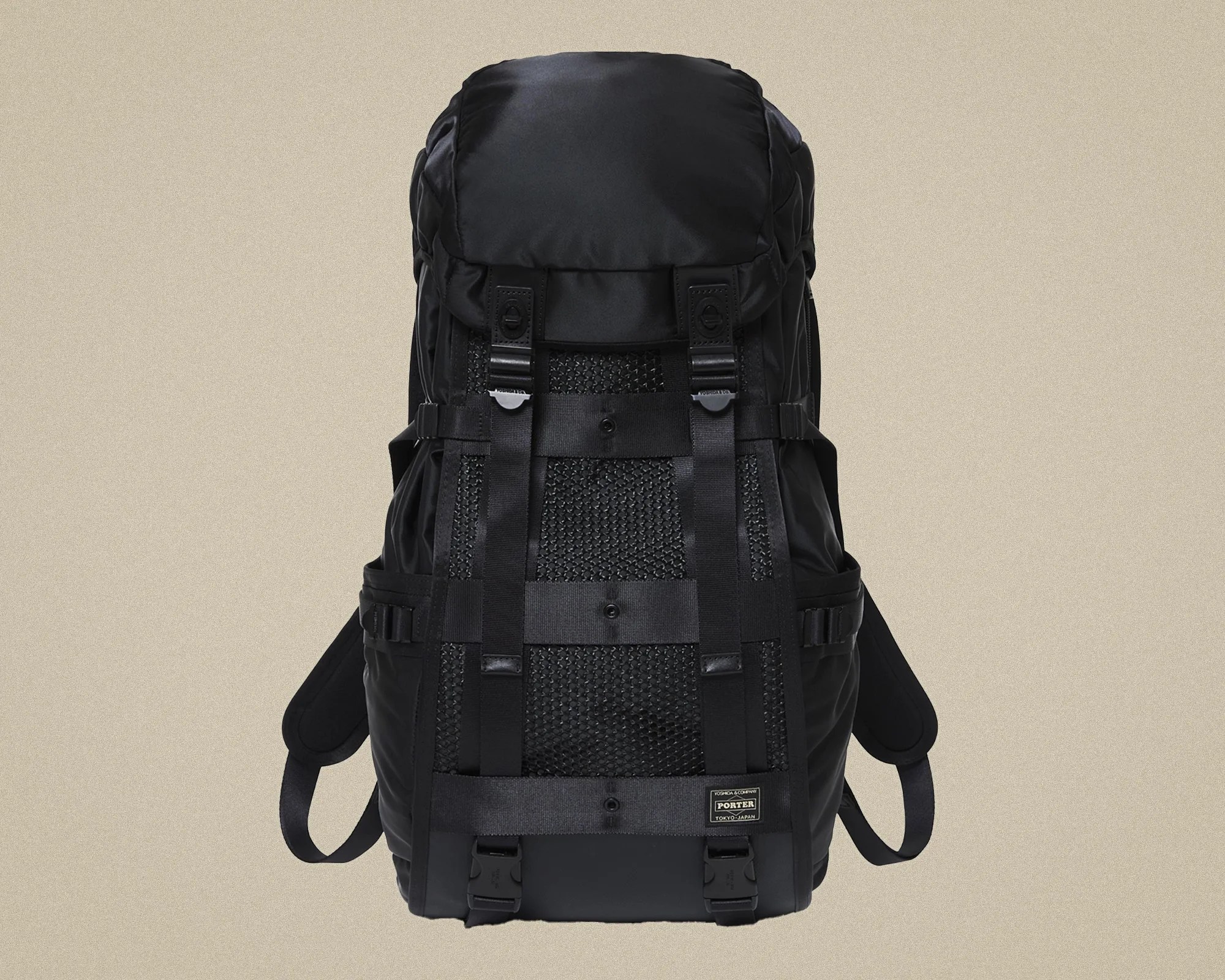 Black nylon backpack with mesh front panel, adjustable straps, and "Porter Tokyo Japan" label.