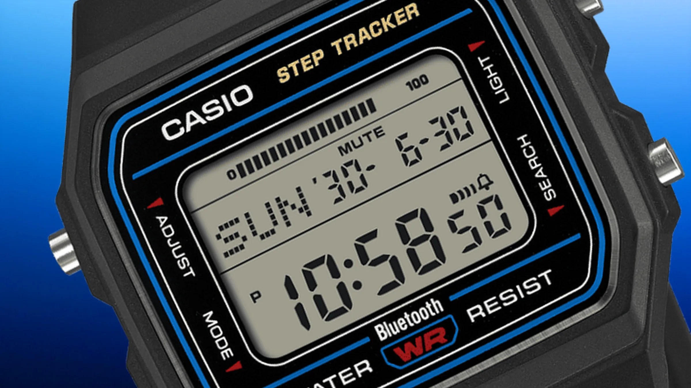 Close-up of a black Casio digital step tracker watch displaying date, time, and Bluetooth connectivity.