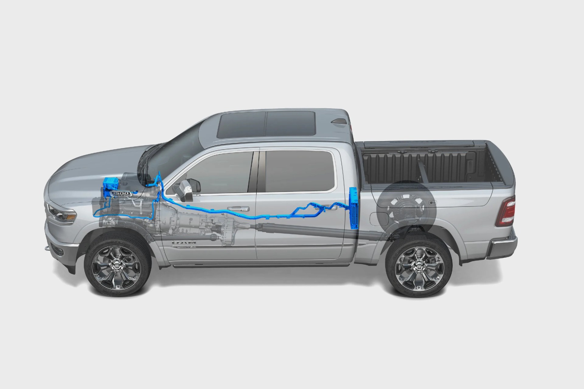 Silver pickup truck with transparent body showing internal engine, transmission, and blue electrical wiring system.