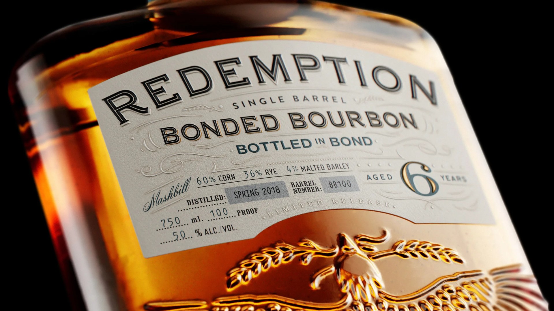 Close-up of a Redemption Bonded Bourbon bottle label showing 6 years aged, 60% corn, 36% rye, 4% malted barley, and 50% alcohol.