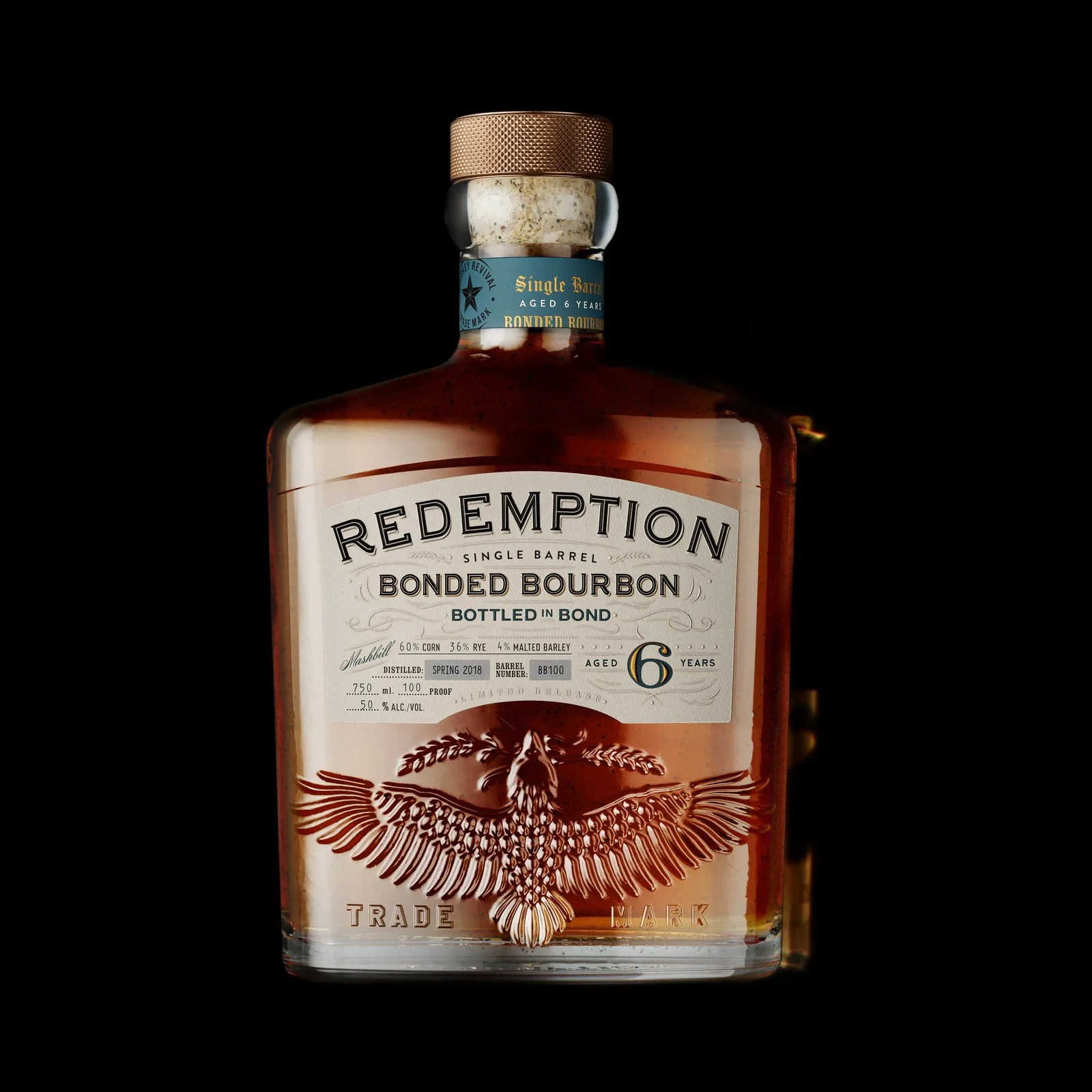 Clear glass bottle of Redemption Bonded Bourbon with embossed eagle and copper textured cap on black background.