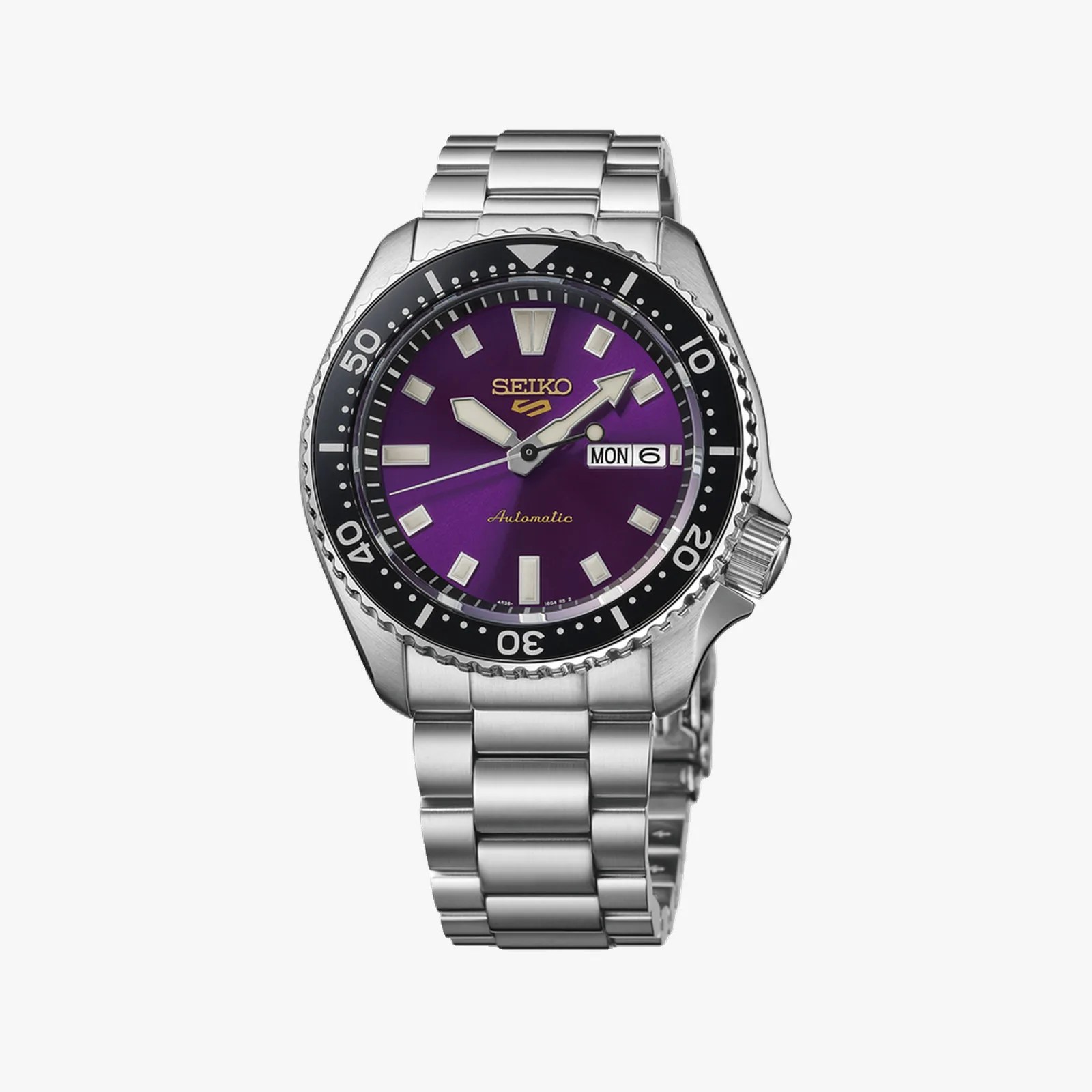 Seiko automatic wristwatch with a purple dial, silver markers, black bezel, and stainless steel bracelet.