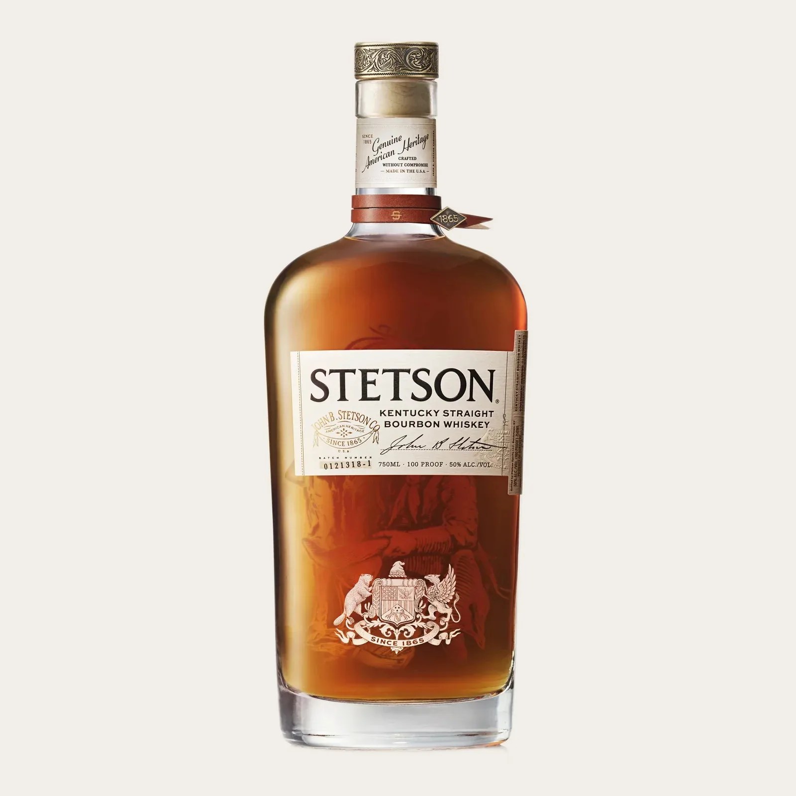 Amber bourbon whiskey in a clear glass bottle with a white label reading "Stetson Kentucky Straight Bourbon Whiskey.