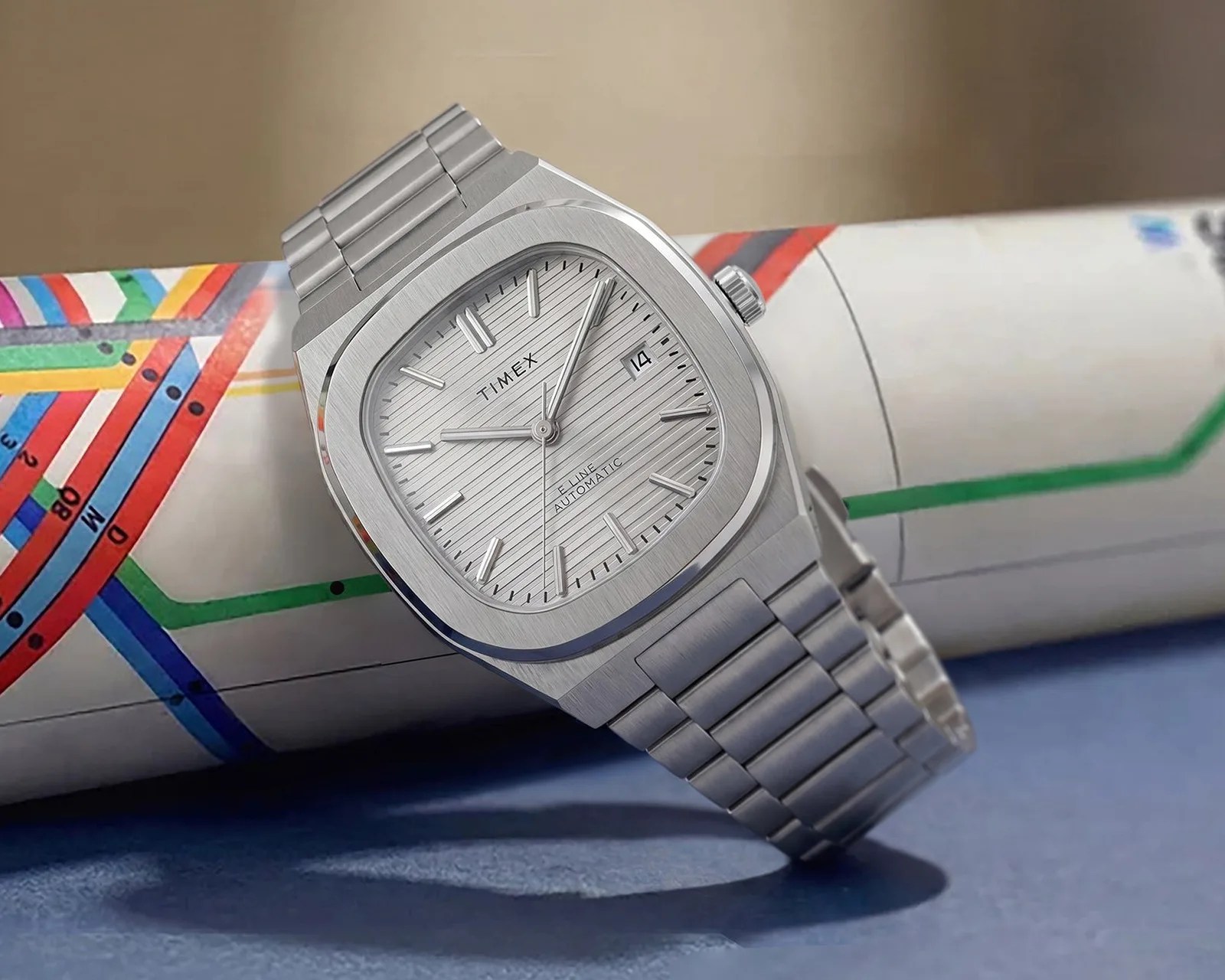 Silver Timex wristwatch with a rectangular brushed metal case and matching metal link bracelet.